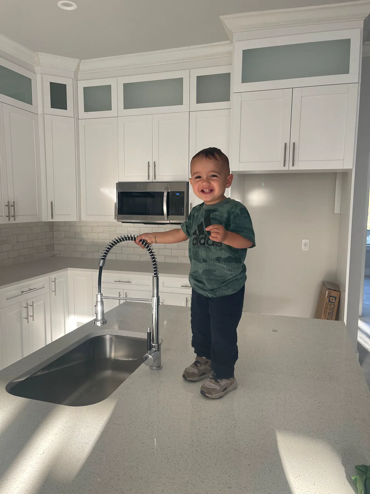 XL Homes family inspecting finished luxury kitchen Naples custom home