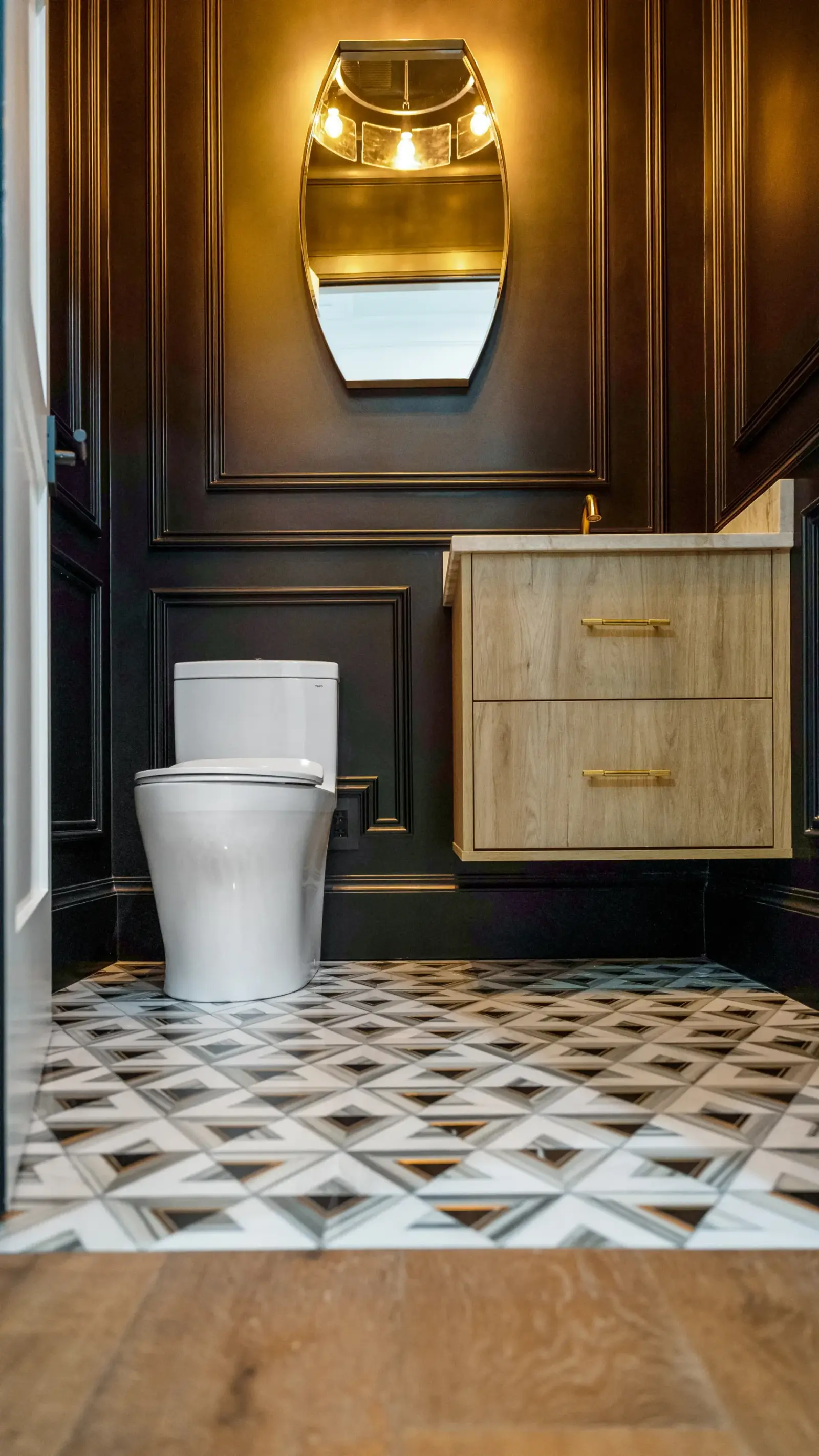Luxury spa bathroom with marble tiles and designer fixtures in The Emerald Mediterranean revival home at 210 16th Ave NE, Naples FL by XL Homes custom home builder