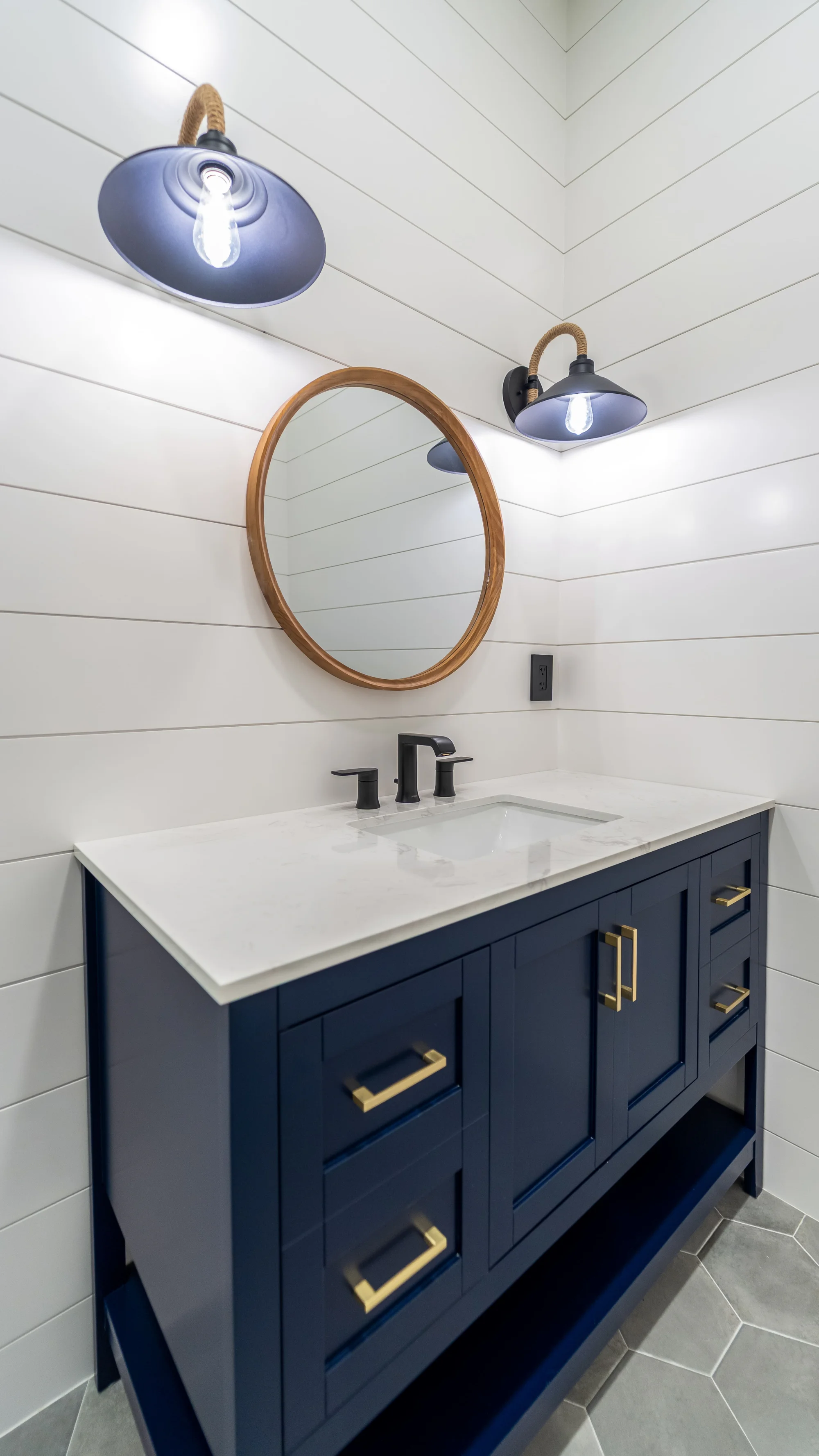 Luxury spa bathroom with marble tiles and designer fixtures in The Emerald Mediterranean revival home at 210 16th Ave NE, Naples FL by XL Homes custom home builder