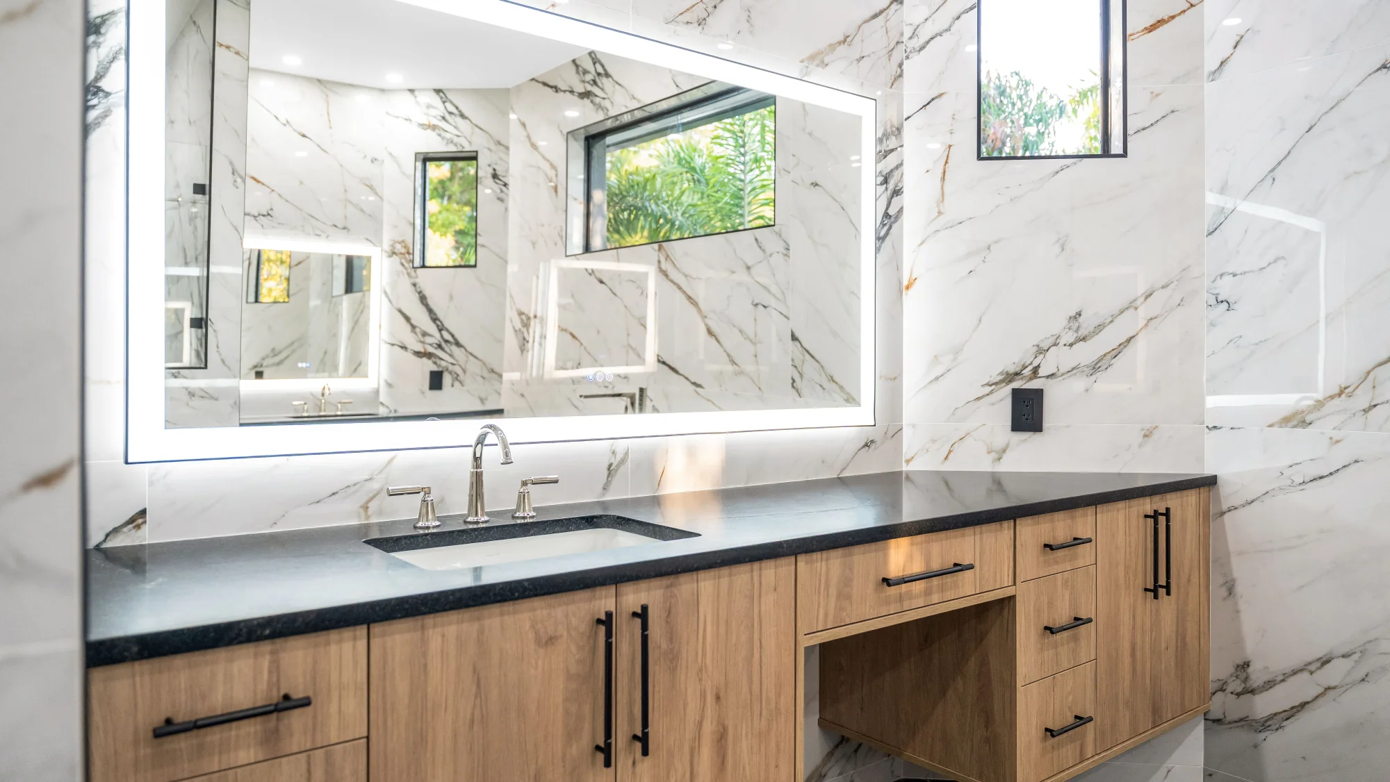 Luxury spa bathroom with marble tiles and designer fixtures in The Emerald Mediterranean revival home at 210 16th Ave NE, Naples FL by XL Homes custom home builder