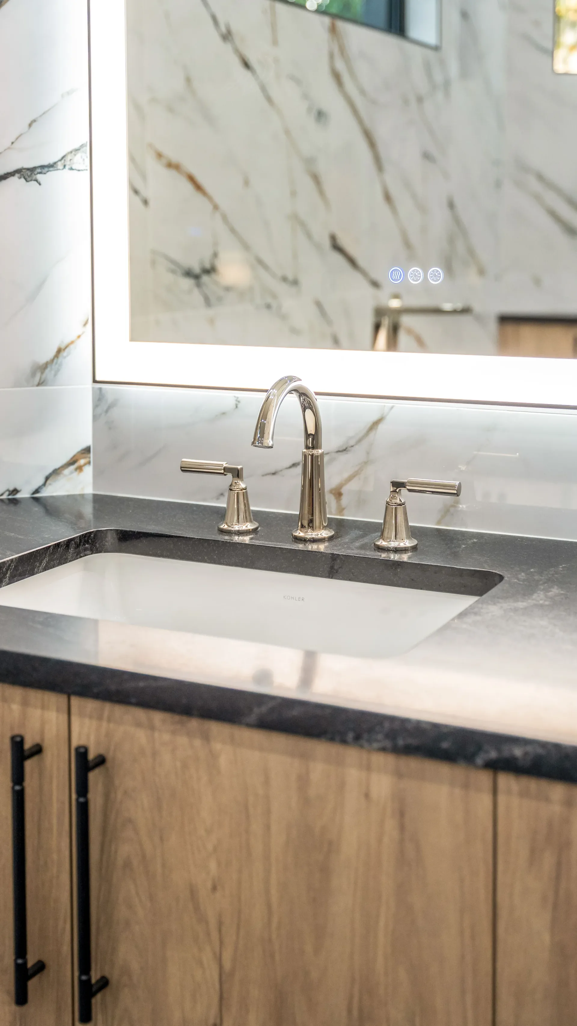 Luxury spa bathroom with marble tiles and designer fixtures in The Emerald Mediterranean revival home at 210 16th Ave NE, Naples FL by XL Homes custom home builder