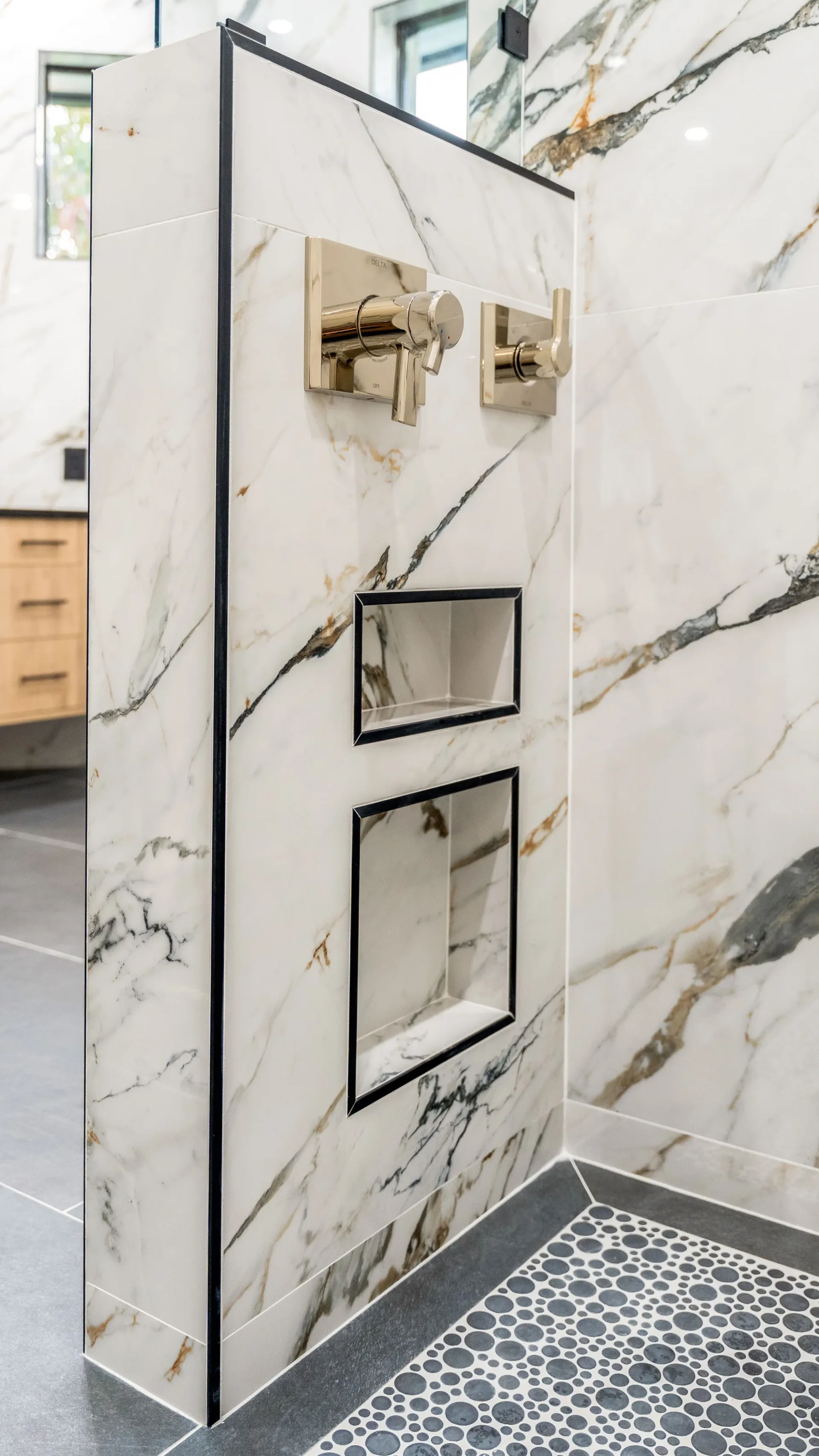 Luxury spa bathroom with marble tiles and designer fixtures in The Emerald Mediterranean revival home at 210 16th Ave NE, Naples FL by XL Homes custom home builder