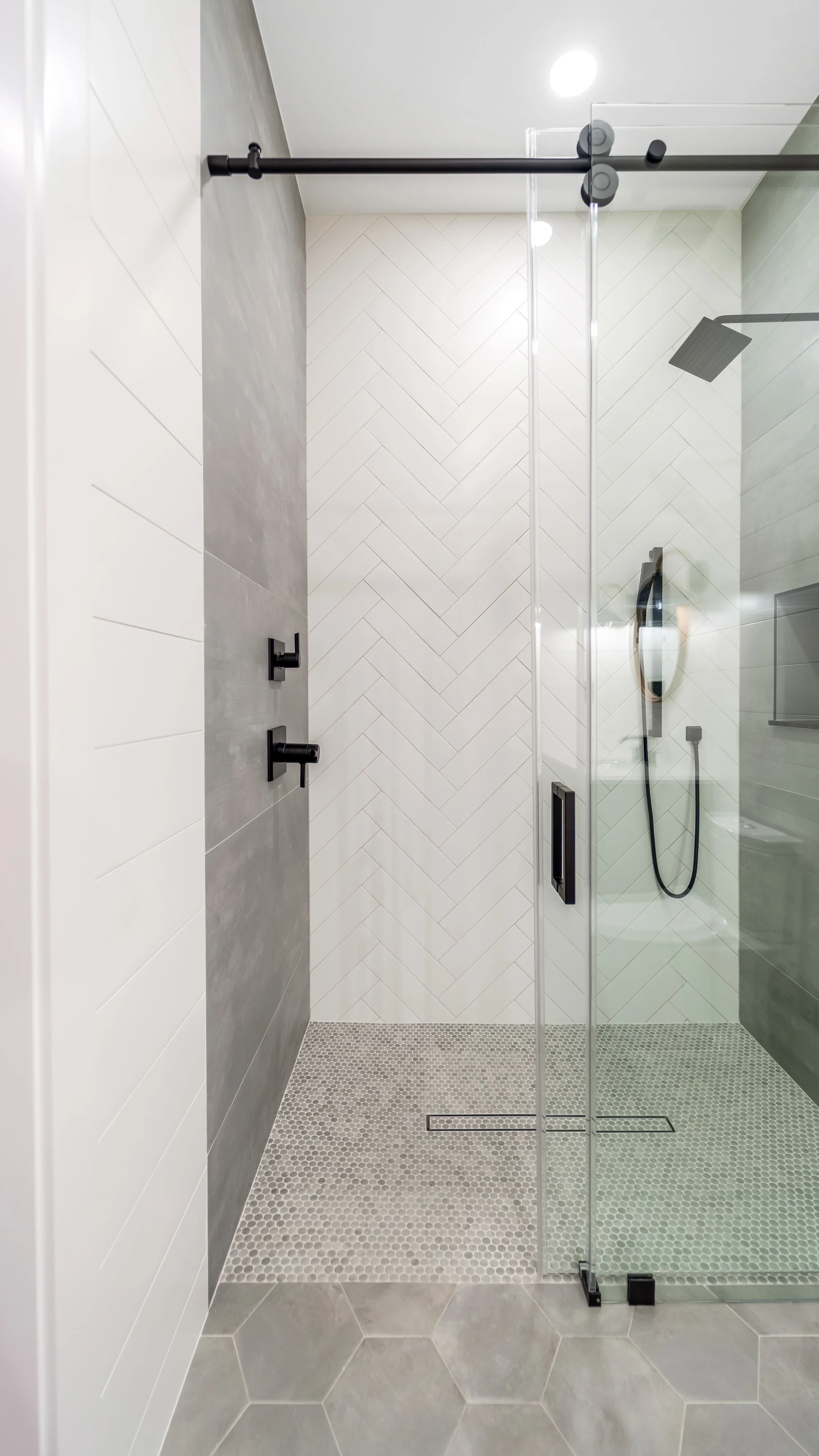 Luxury spa bathroom with marble tiles and designer fixtures in The Emerald Mediterranean revival home at 210 16th Ave NE, Naples FL by XL Homes custom home builder