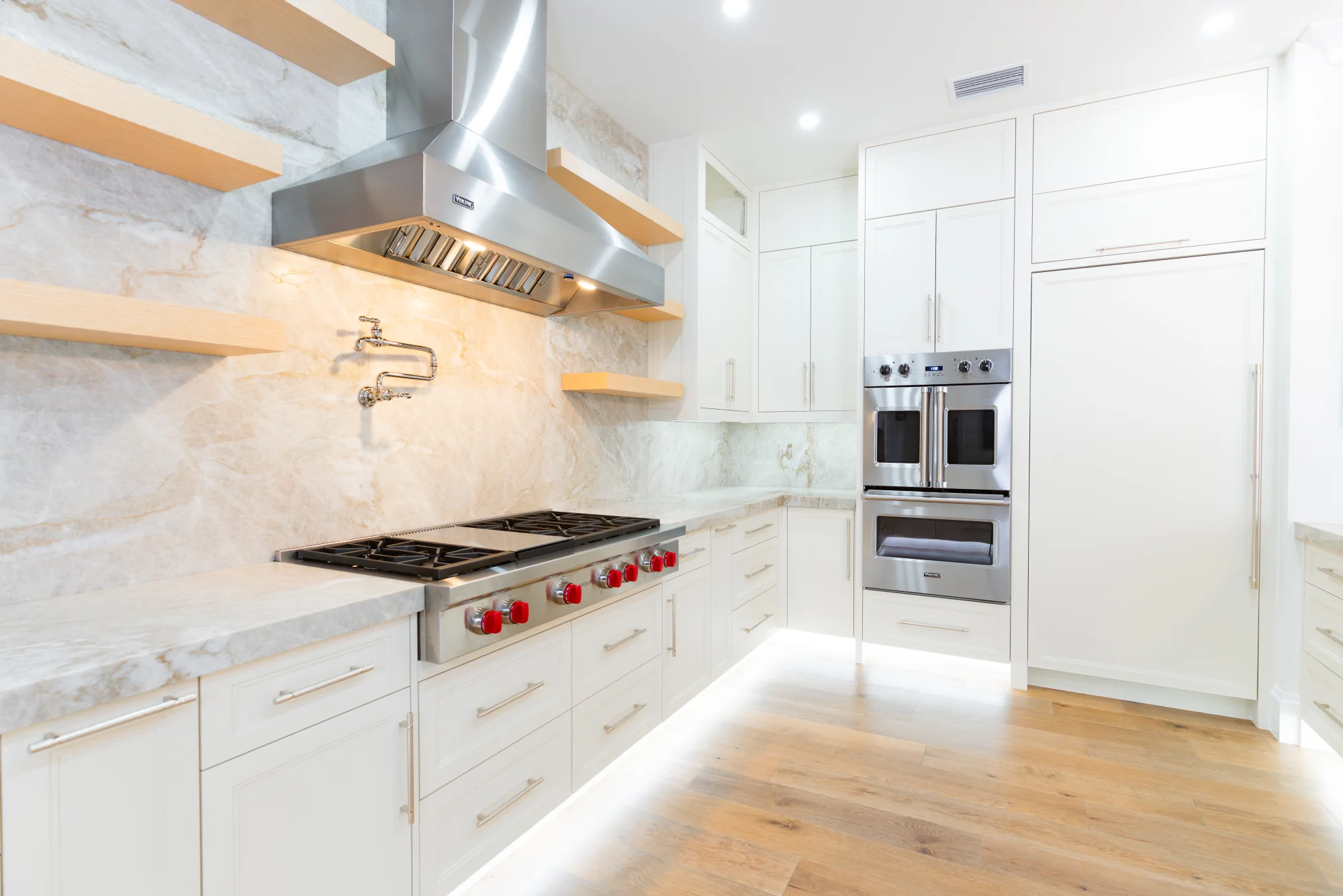 Gourmet kitchen with quartz countertops and custom cabinetry in The Emerald Mediterranean revival home at 210 16th Ave NE, Naples FL by XL Homes custom home builder