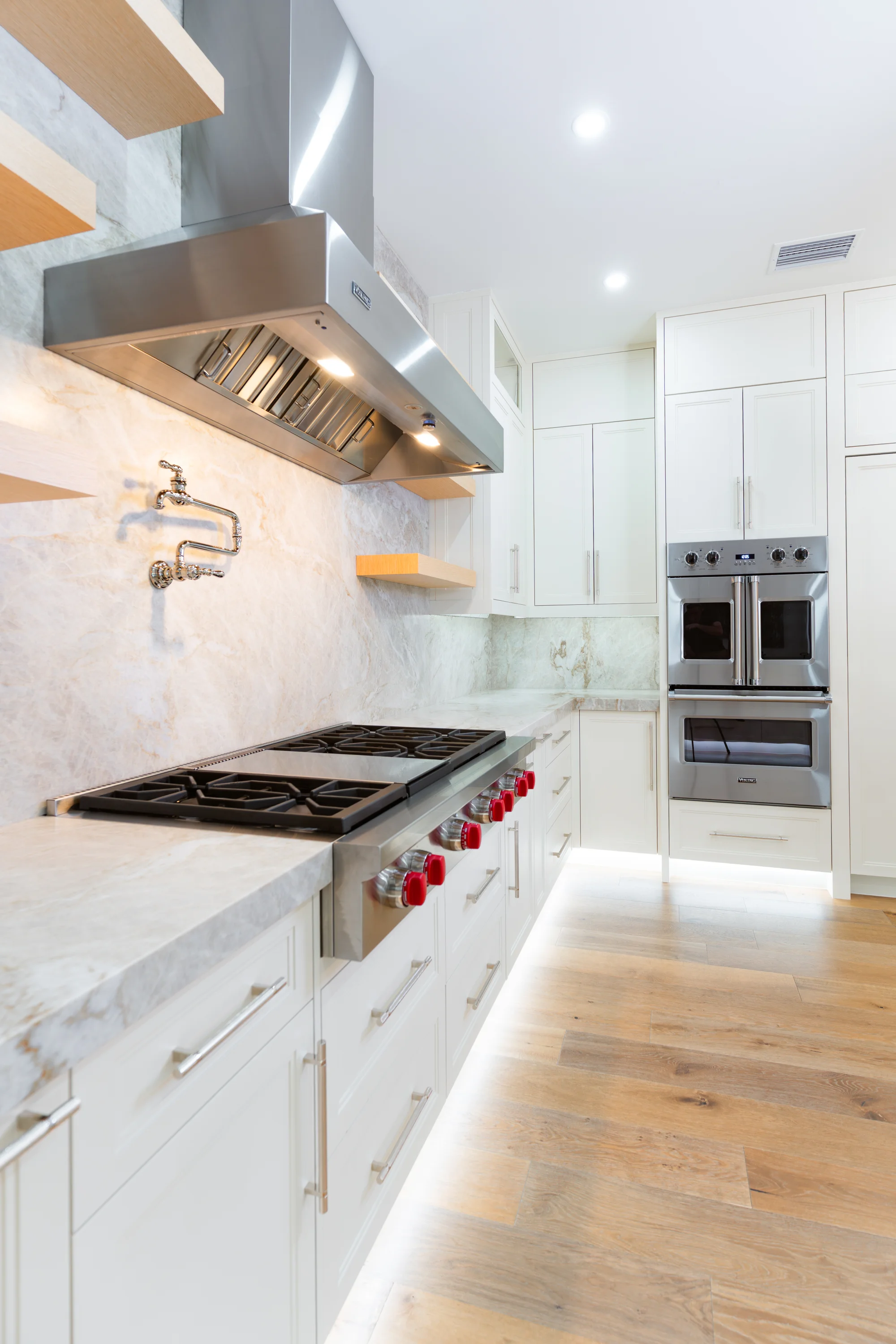 Gourmet kitchen with quartz countertops and custom cabinetry in The Emerald Mediterranean revival home at 210 16th Ave NE, Naples FL by XL Homes custom home builder