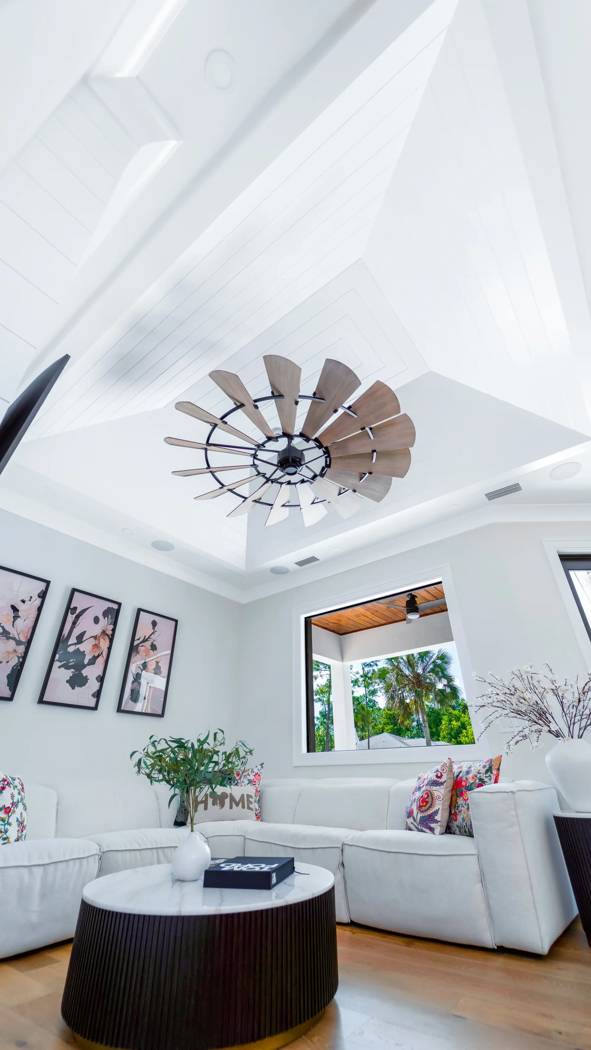 Open concept living room with high ceilings and natural light in The Emerald Mediterranean revival home at 210 16th Ave NE, Naples FL by XL Homes custom home builder