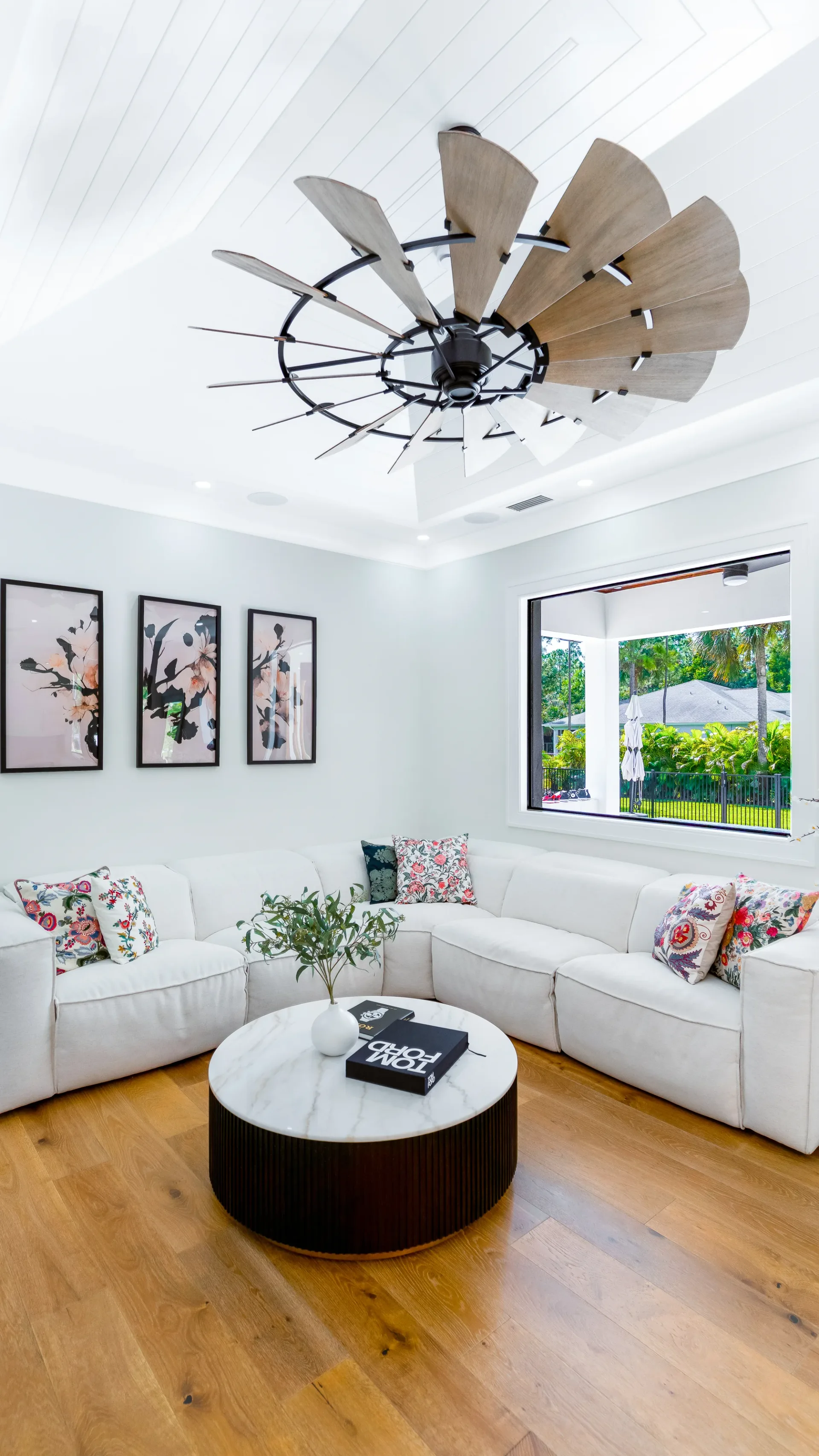 Open concept living room with high ceilings and natural light in The Emerald Mediterranean revival home at 210 16th Ave NE, Naples FL by XL Homes custom home builder