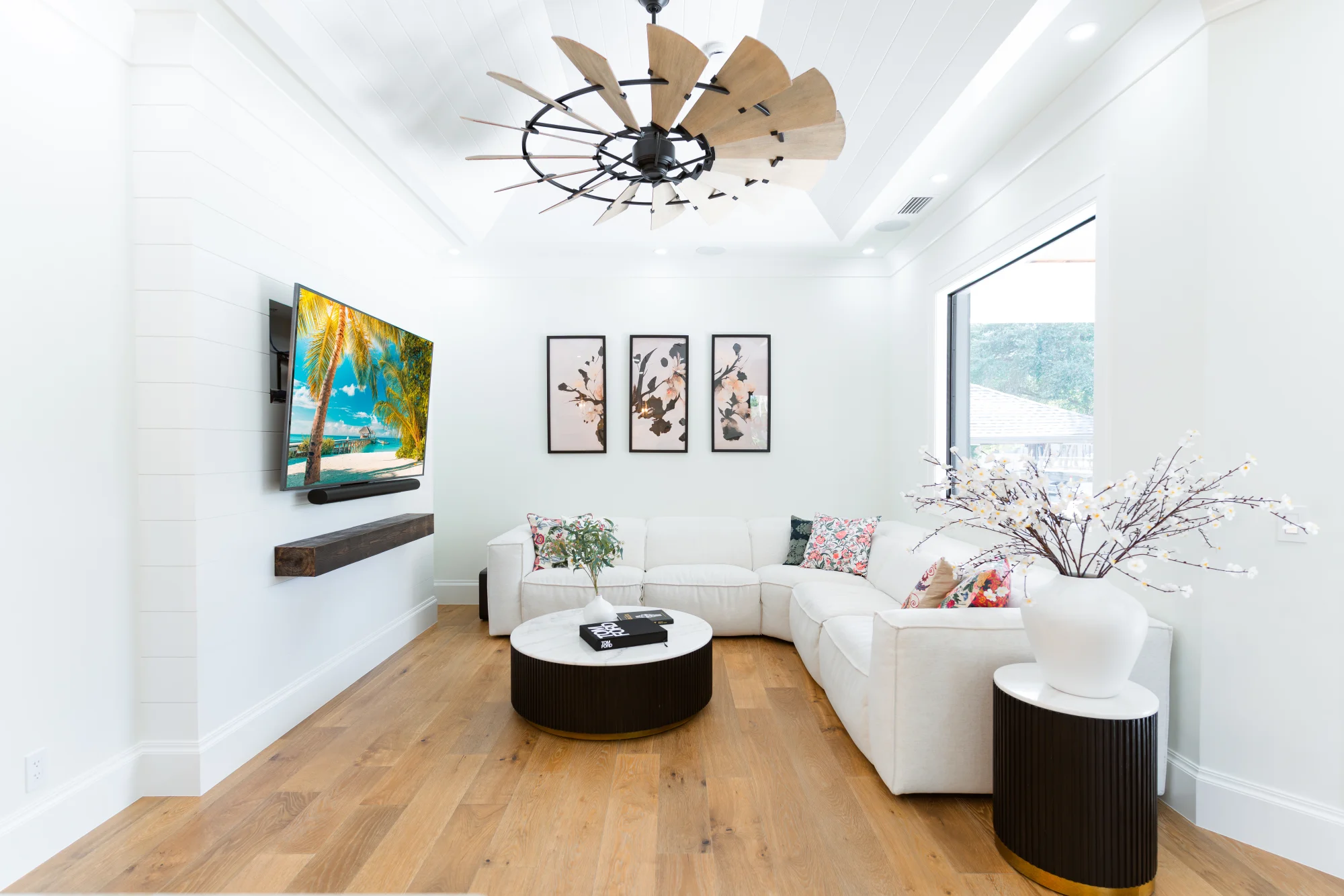 Open concept living room with high ceilings and natural light in The Emerald Mediterranean revival home at 210 16th Ave NE, Naples FL by XL Homes custom home builder