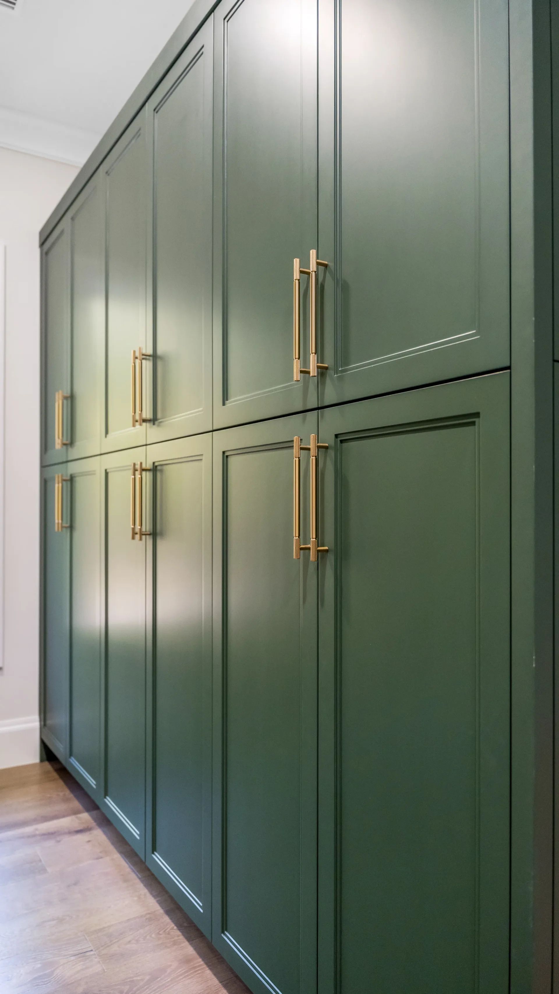 Walk-in pantry with custom shelving and organization in The Emerald Mediterranean revival home at 210 16th Ave NE, Naples FL by XL Homes custom home builder
