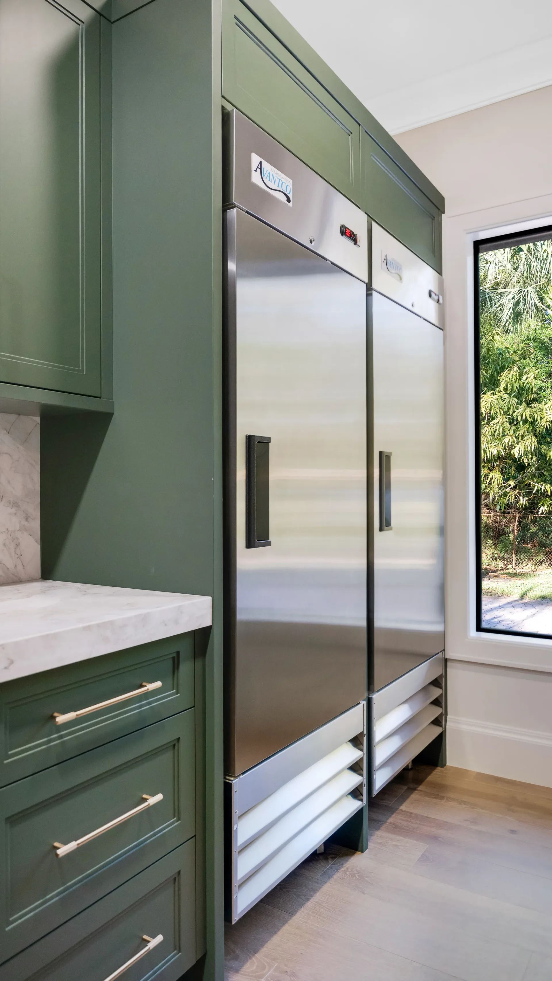 Walk-in pantry with custom shelving and organization in The Emerald Mediterranean revival home at 210 16th Ave NE, Naples FL by XL Homes custom home builder