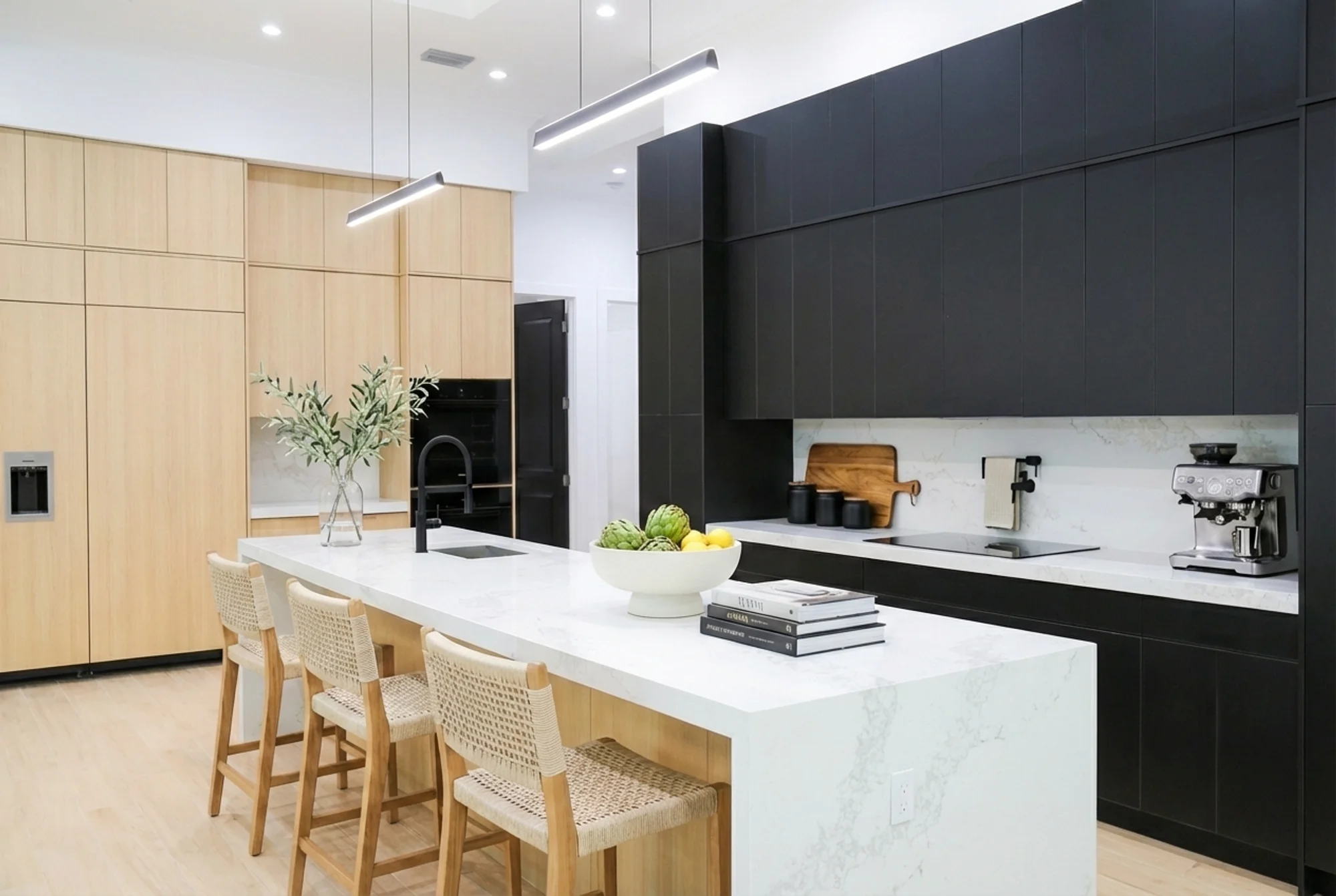 Gourmet kitchen with quartz countertops and custom cabinetry in The Cypress transitional luxury home at 3276 11th Ave SW, Naples FL by XL Homes custom home builder