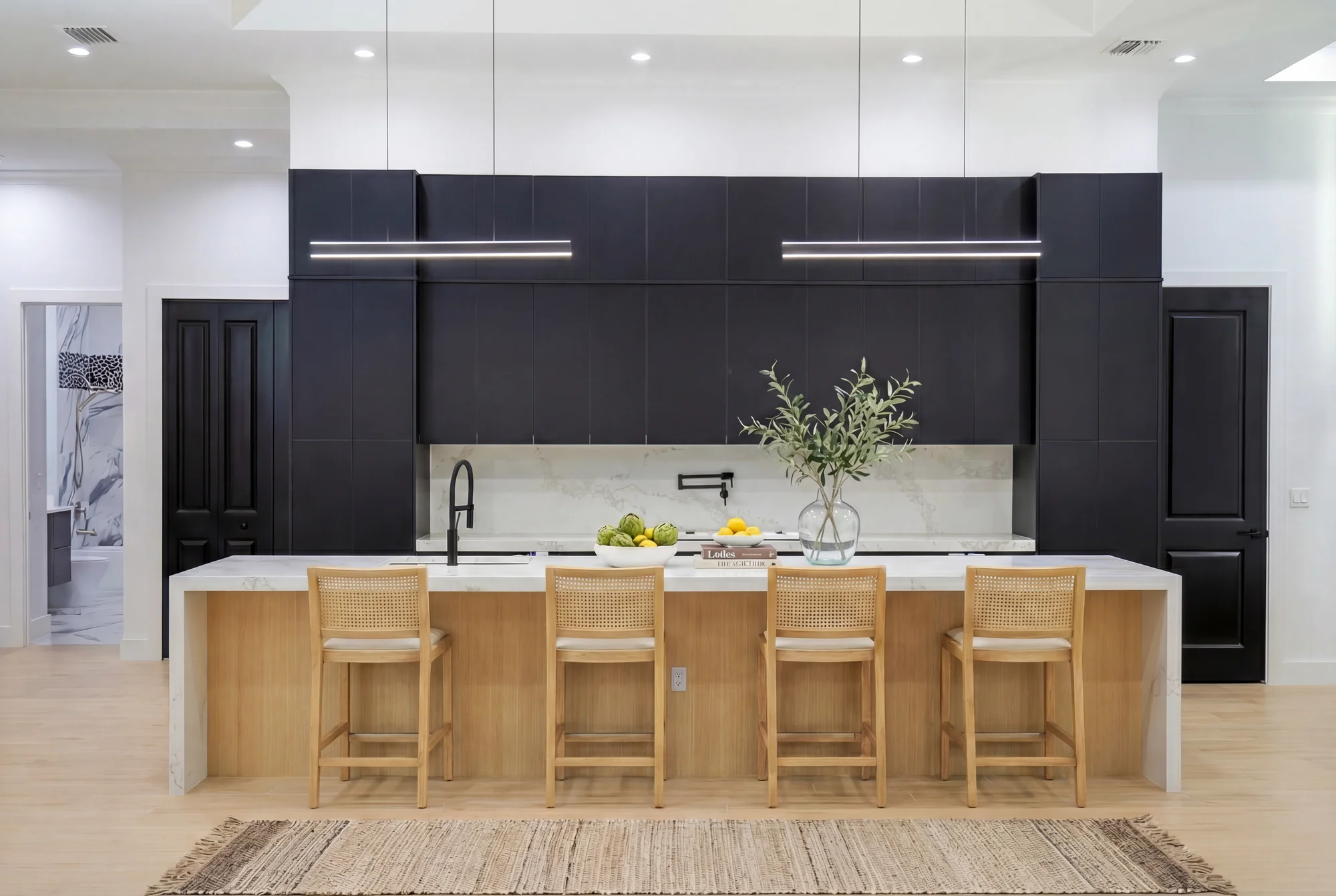 Gourmet kitchen with quartz countertops and custom cabinetry in The Cypress transitional luxury home at 3276 11th Ave SW, Naples FL by XL Homes custom home builder