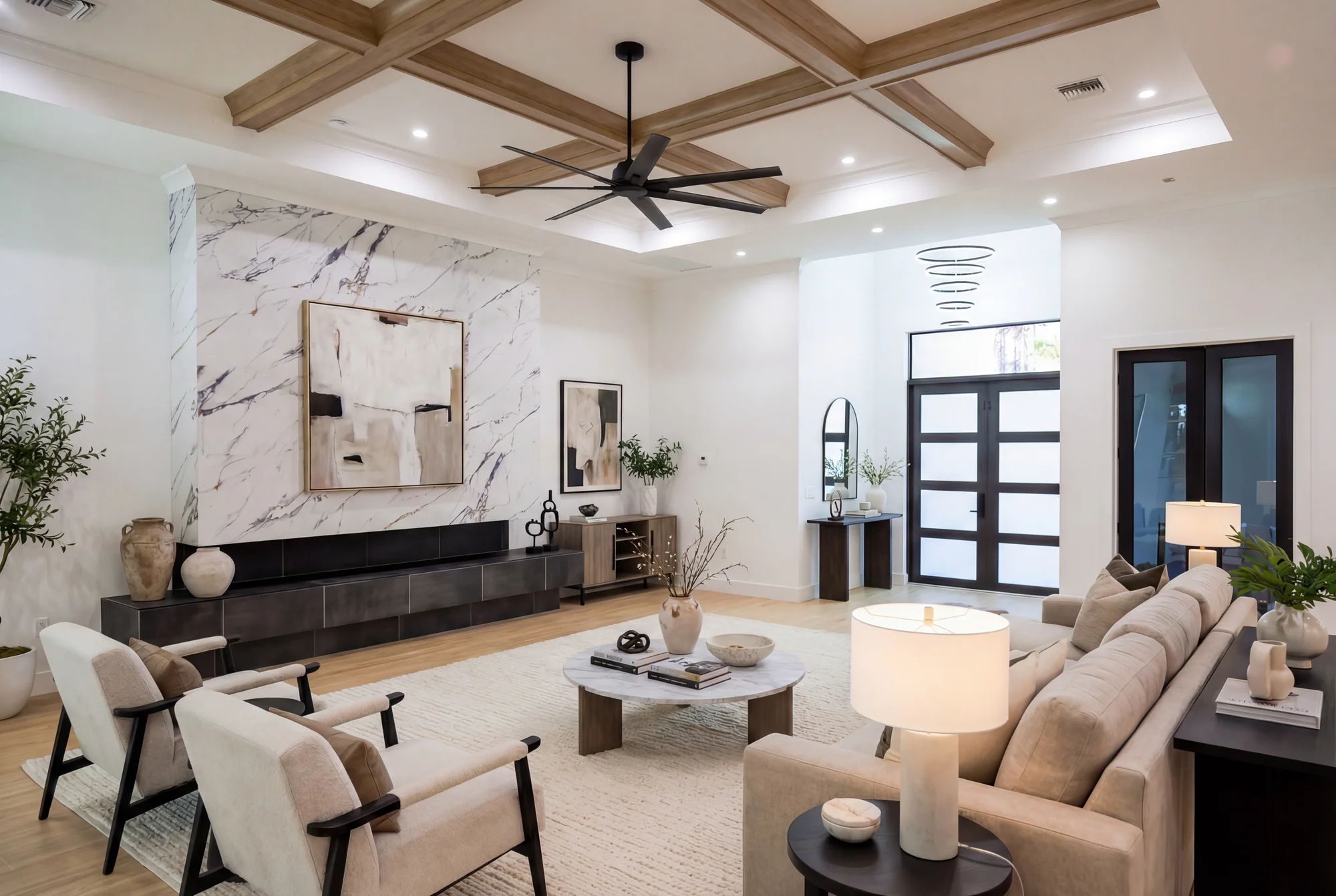 Open concept living room with high ceilings and natural light in The Cypress transitional luxury home at 3276 11th Ave SW, Naples FL by XL Homes custom home builder