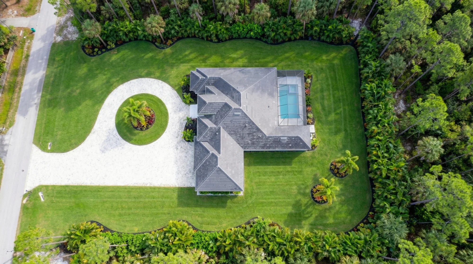Aerial drone view showcasing luxury estate and neighborhood in Sunset Golf modern golf estate home at 524 22nd Ave NW, Naples FL by XL Homes custom home builder