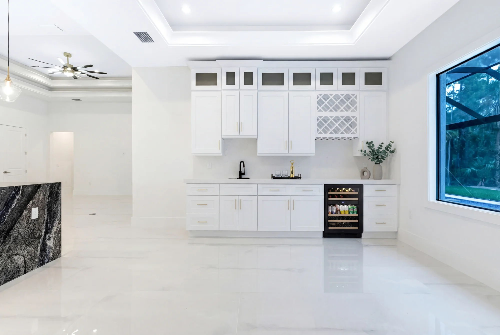 Custom home bar with premium finishes and lighting in Sunset Golf modern golf estate home at 524 22nd Ave NW, Naples FL by XL Homes custom home builder