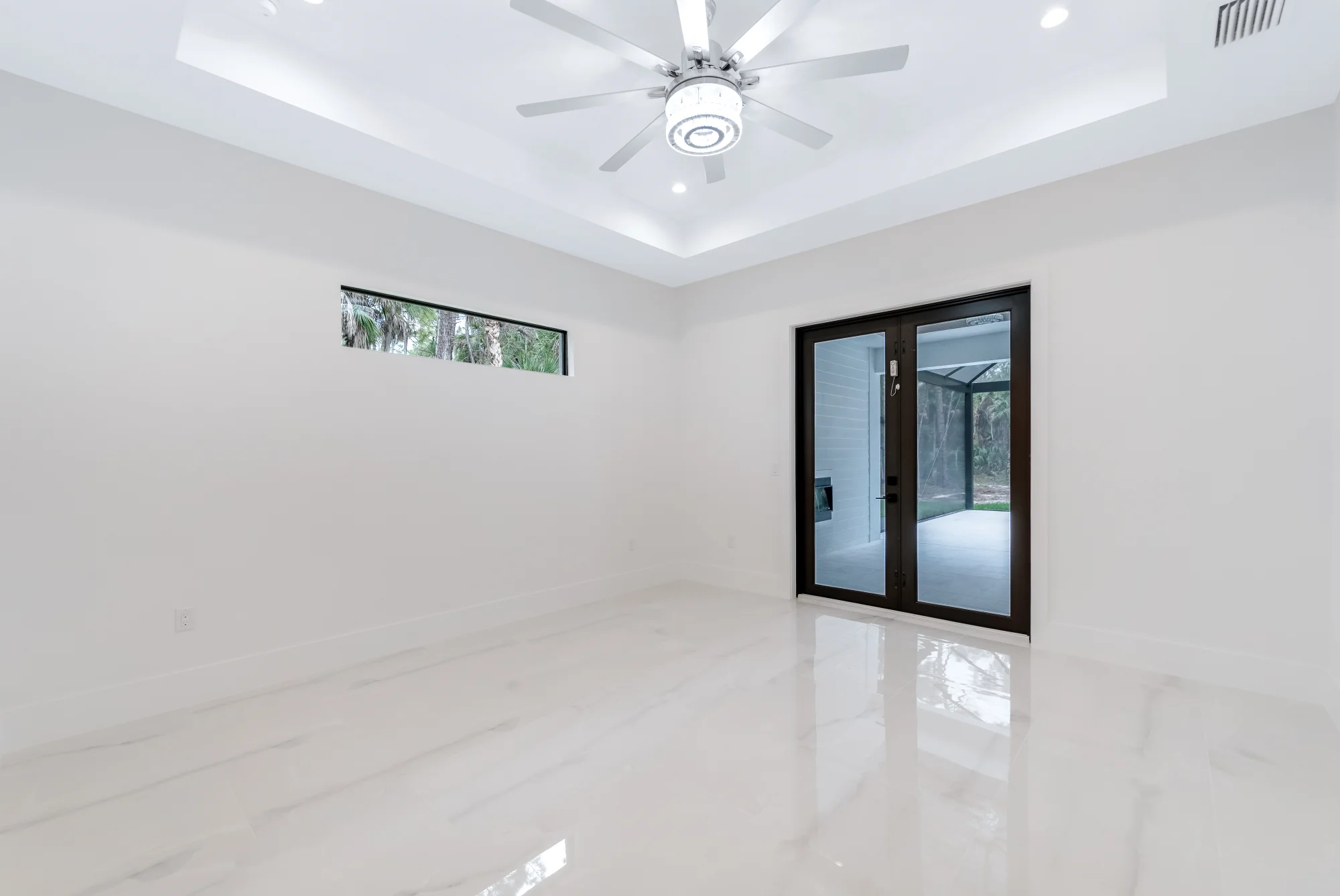 Spacious master suite with tray ceiling and custom millwork in Sunset Golf modern golf estate home at 524 22nd Ave NW, Naples FL by XL Homes custom home builder