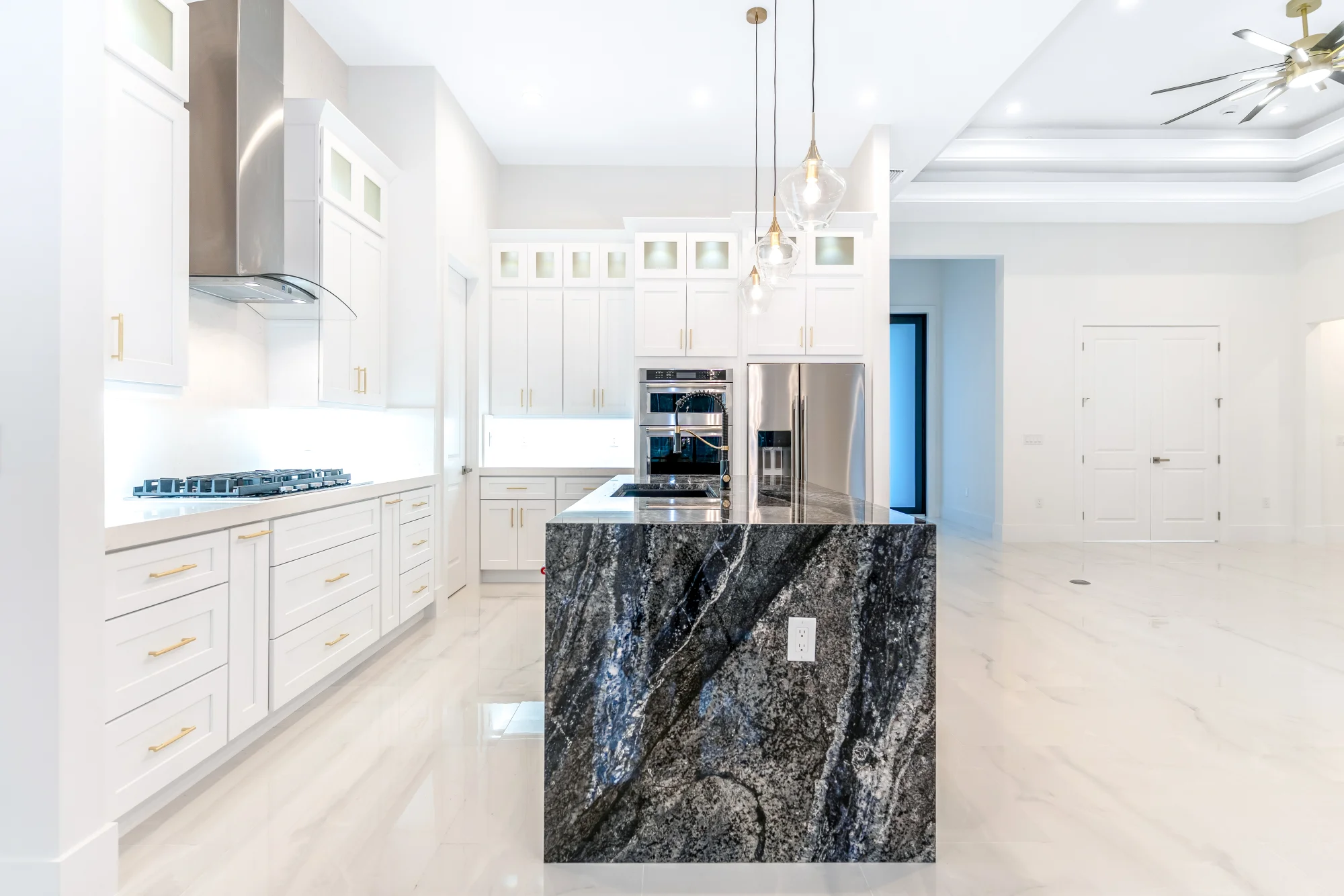 Gourmet kitchen with quartz countertops and custom cabinetry in Sunset Golf modern golf estate home at 524 22nd Ave NW, Naples FL by XL Homes custom home builder