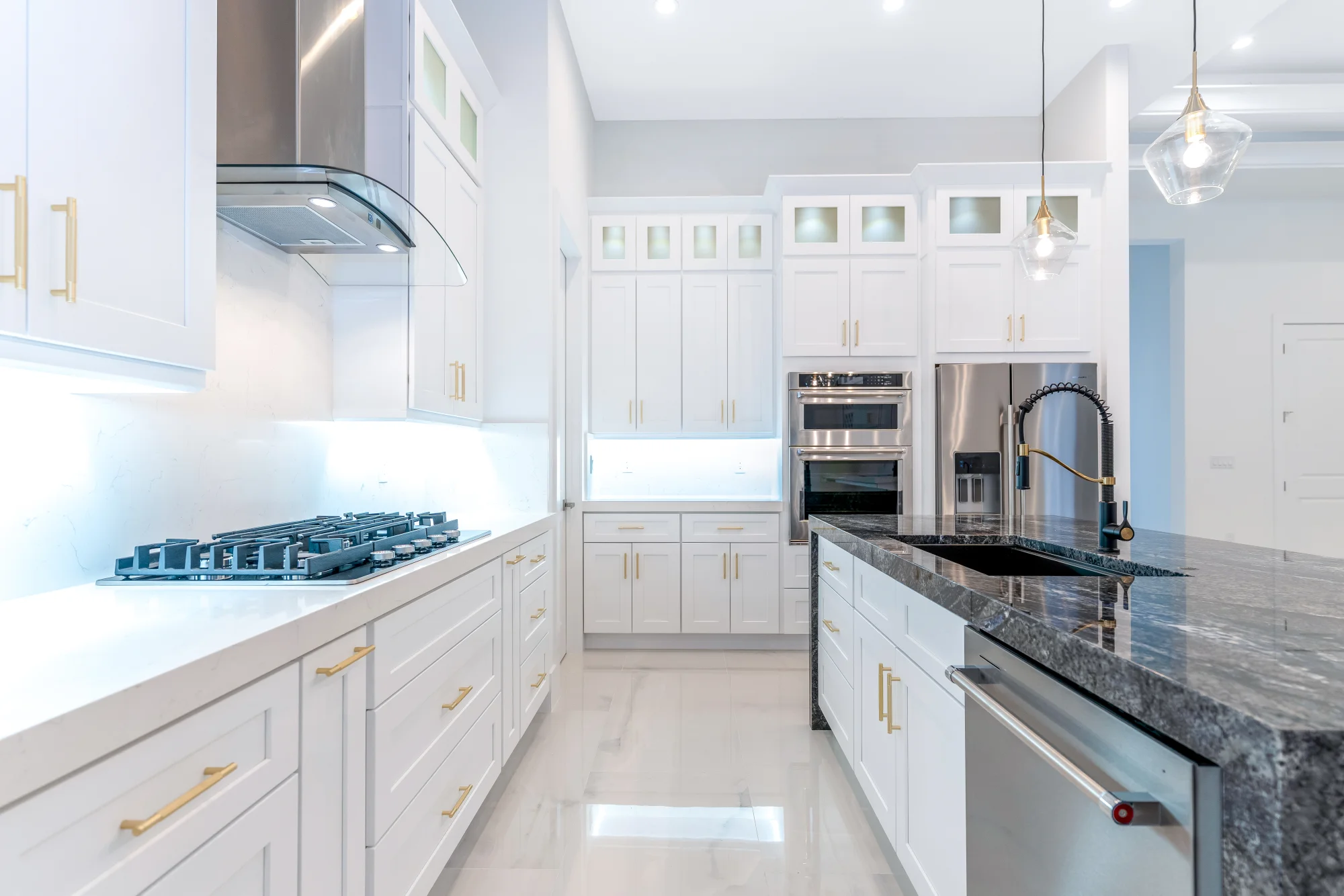 Gourmet kitchen with quartz countertops and custom cabinetry in Sunset Golf modern golf estate home at 524 22nd Ave NW, Naples FL by XL Homes custom home builder