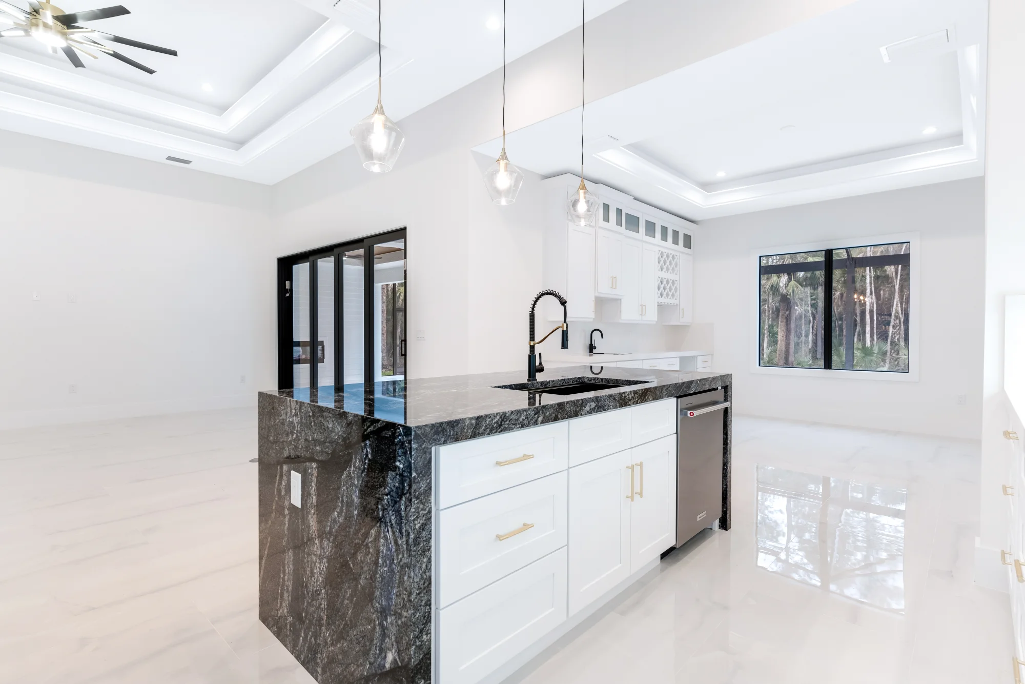 Gourmet kitchen with quartz countertops and custom cabinetry in Sunset Golf modern golf estate home at 524 22nd Ave NW, Naples FL by XL Homes custom home builder