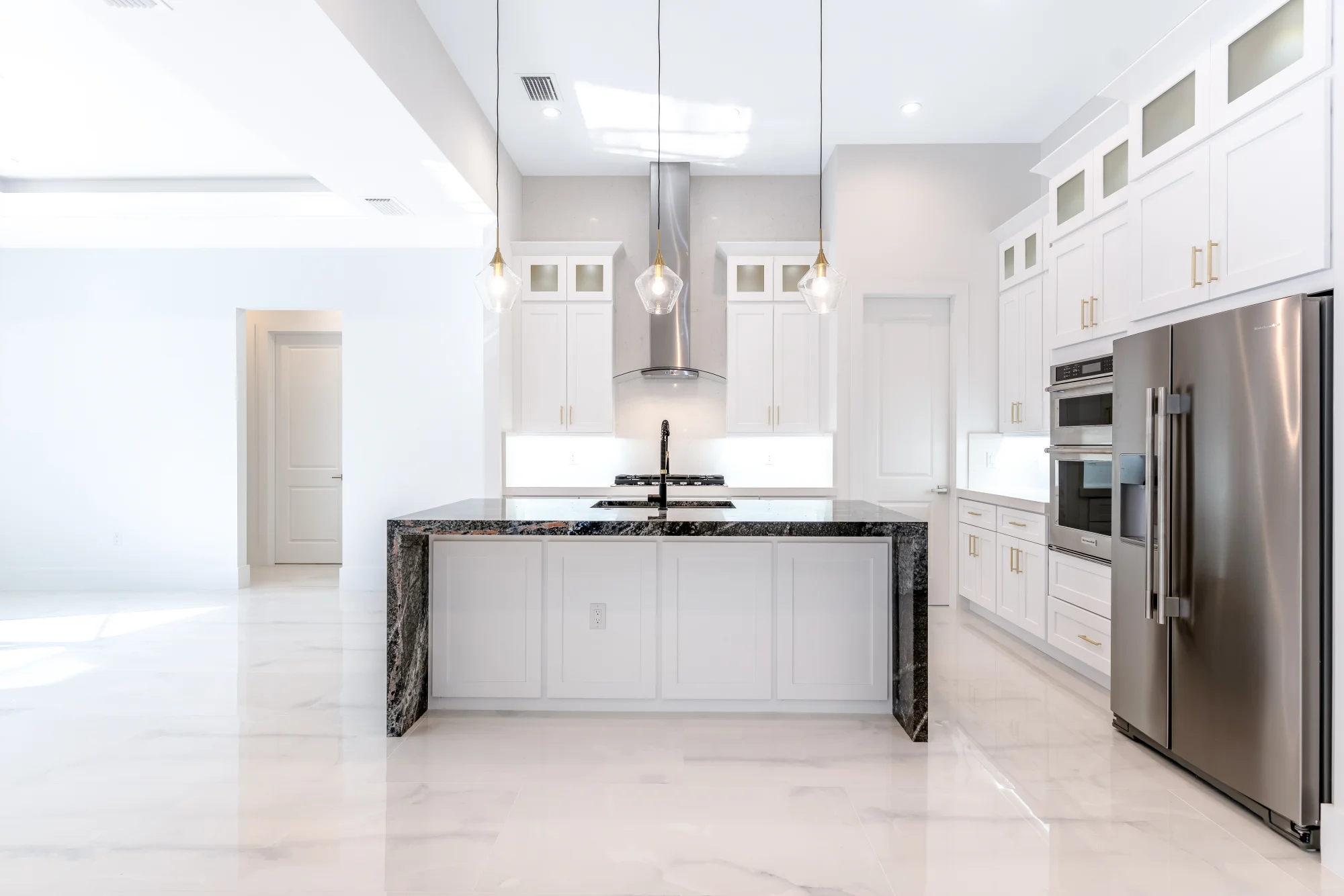 Gourmet kitchen with quartz countertops and custom cabinetry in Sunset Golf modern golf estate home at 524 22nd Ave NW, Naples FL by XL Homes custom home builder