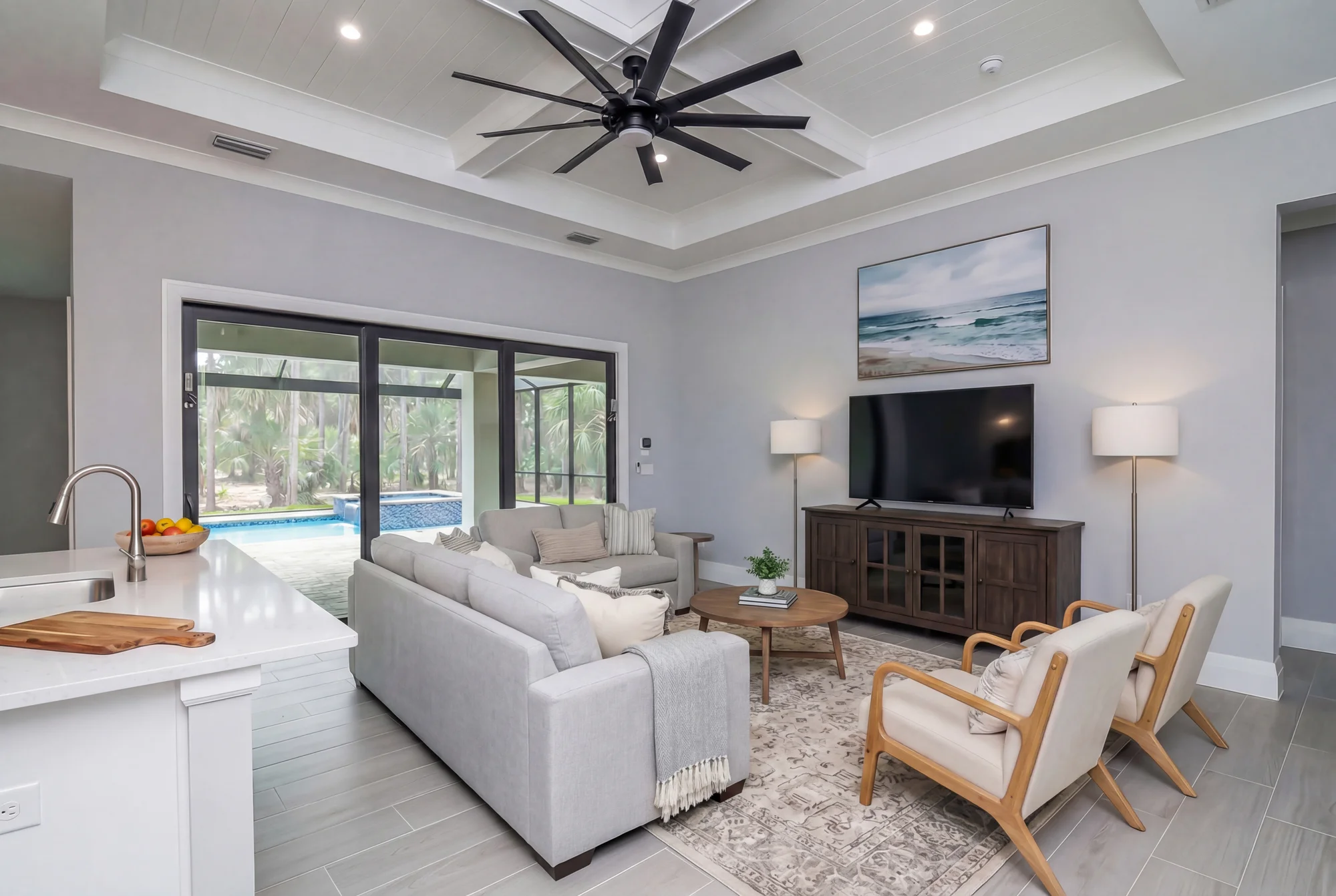 Open concept living room with high ceilings and natural light in The Oasis coastal contemporary home at 760 15th St SW, Naples FL by XL Homes custom home builder
