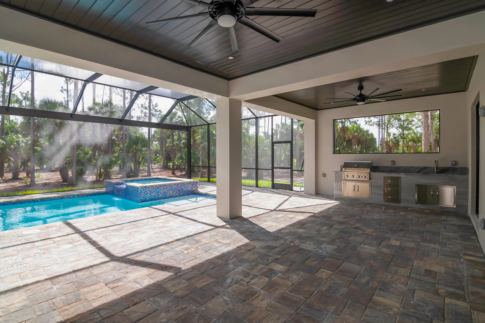 Resort-style pool and screened lanai with outdoor living space in The Oasis coastal contemporary home at 760 15th St SW, Naples FL by XL Homes custom home builder