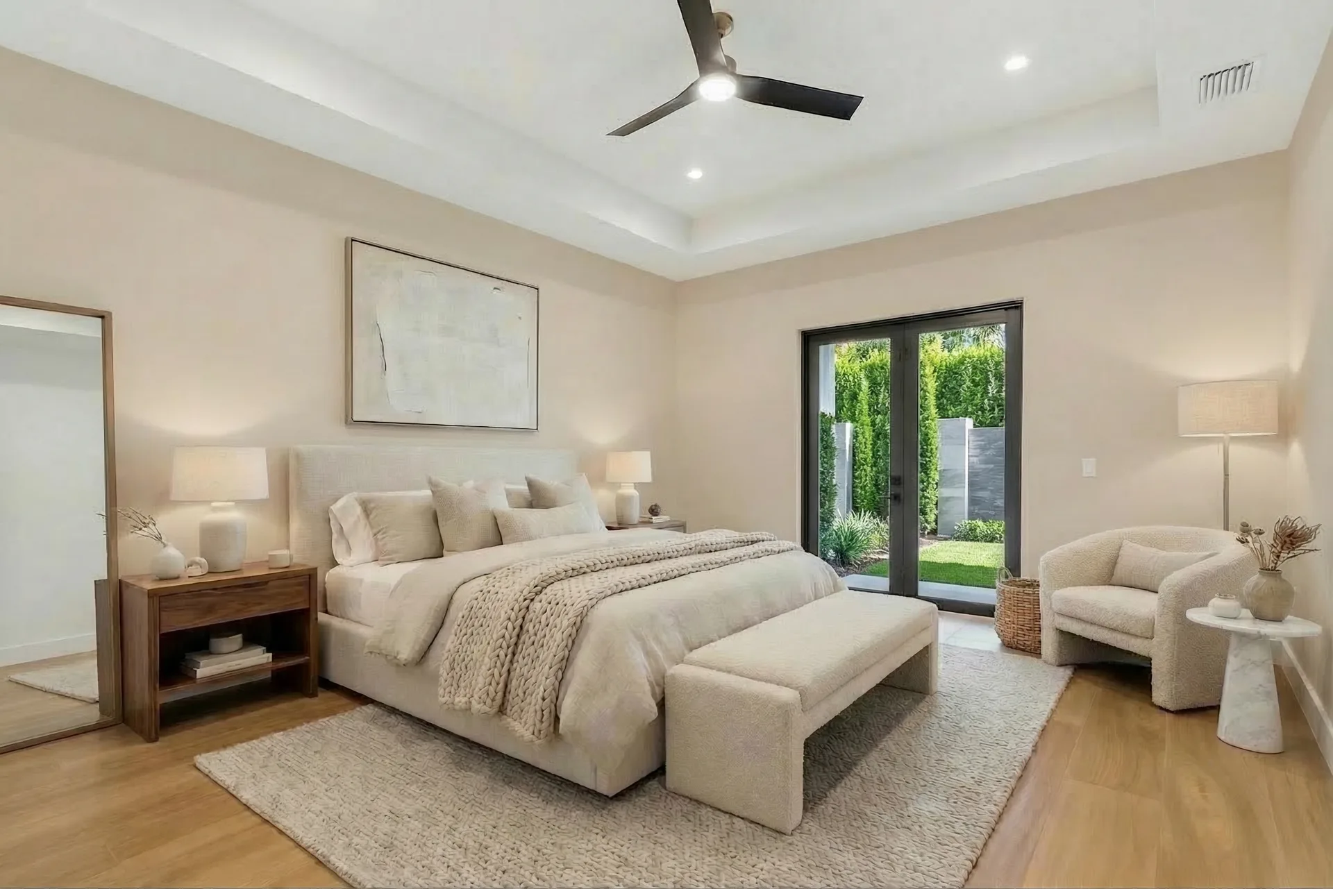 Spacious master suite with tray ceiling and custom millwork in Golden Ridge modern luxury estate home at Naples, FL by XL Homes custom home builder