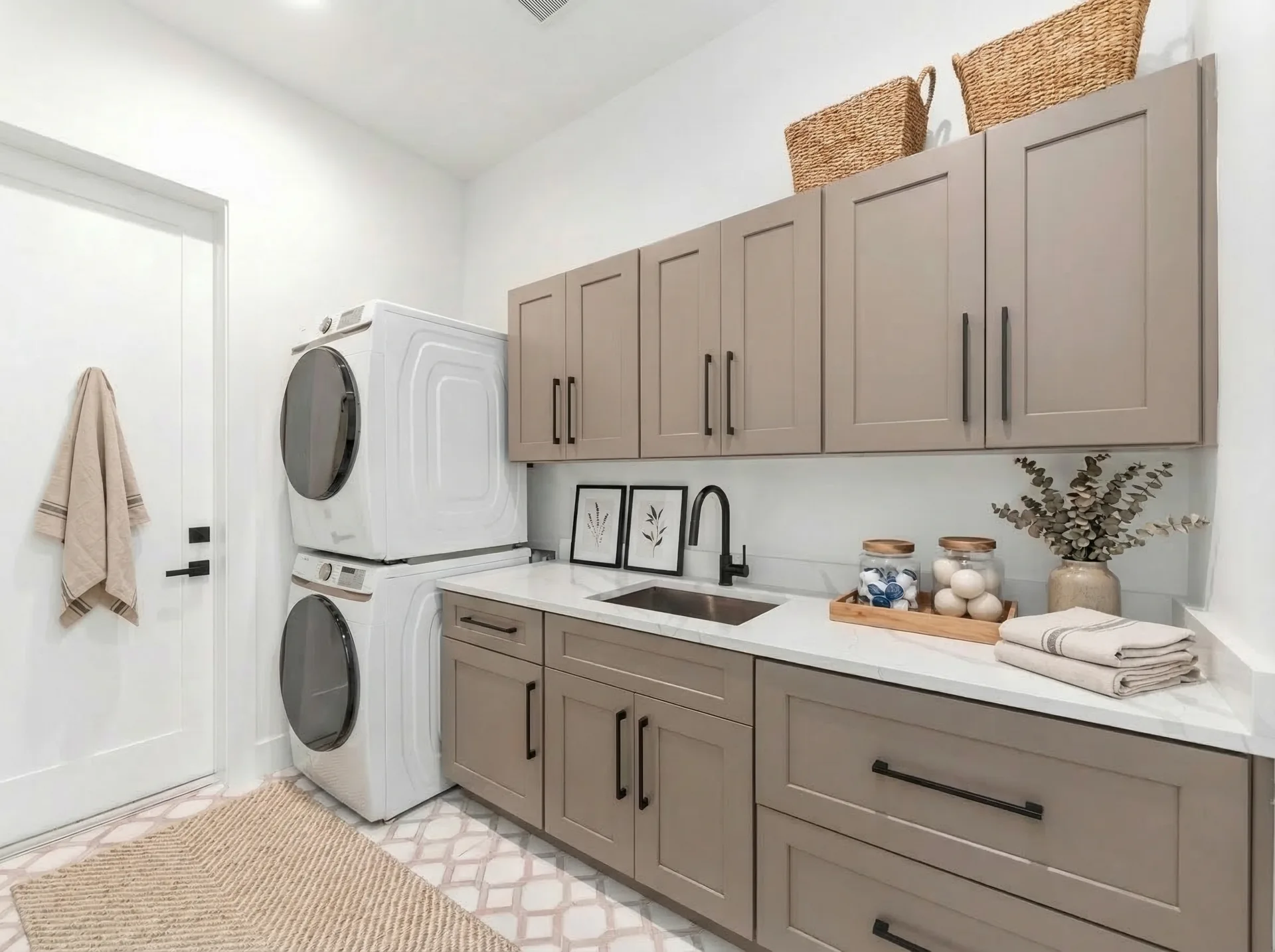 Premium laundry room with quartz countertops and cabinetry in Golden Ridge modern luxury estate home at Naples, FL by XL Homes custom home builder