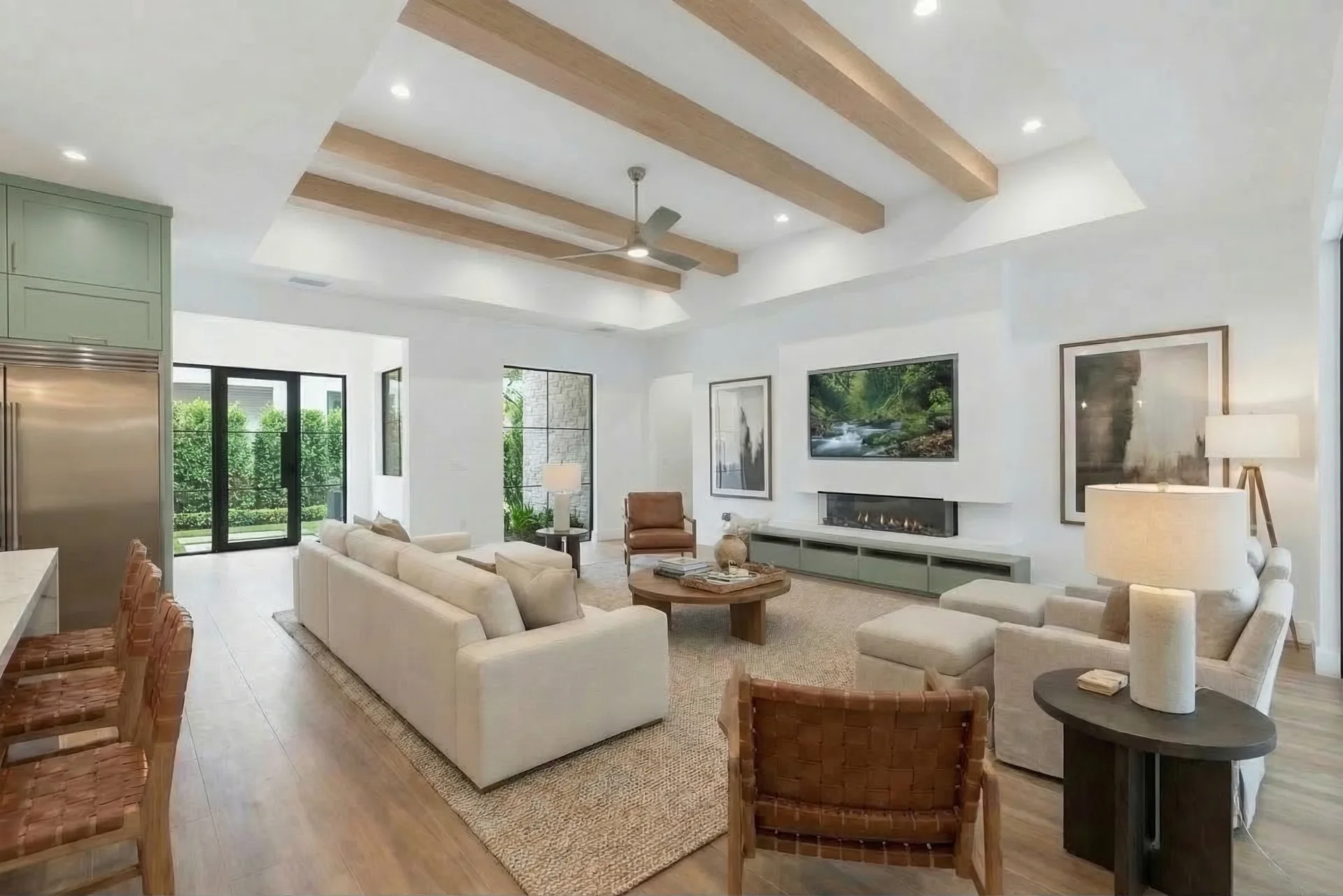 Open concept living room with high ceilings and natural light in Golden Ridge modern luxury estate home at Naples, FL by XL Homes custom home builder