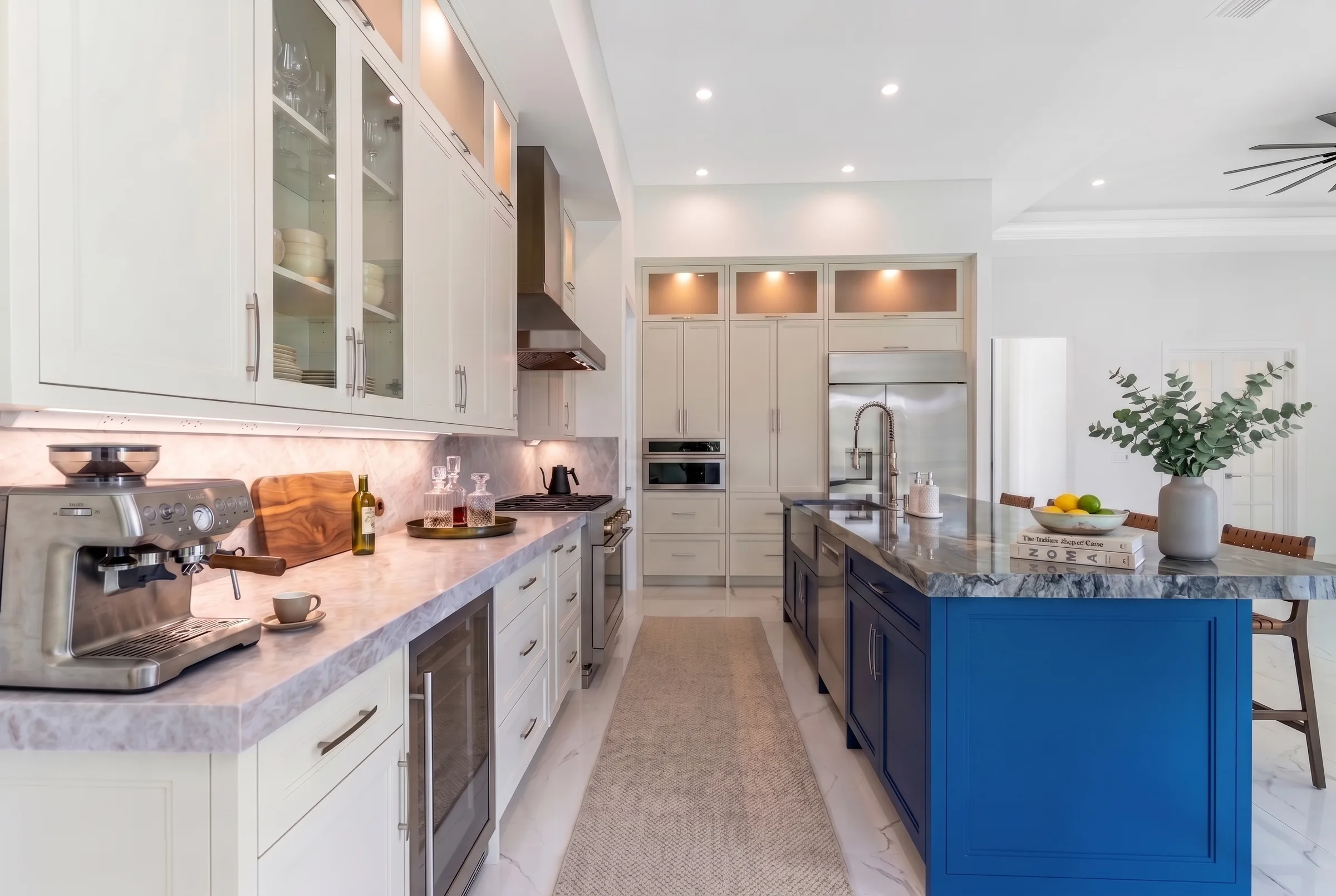 Gourmet kitchen with quartz countertops and custom cabinetry in Rookery Bay transitional coastal luxury home at Naples, FL by XL Homes custom home builder