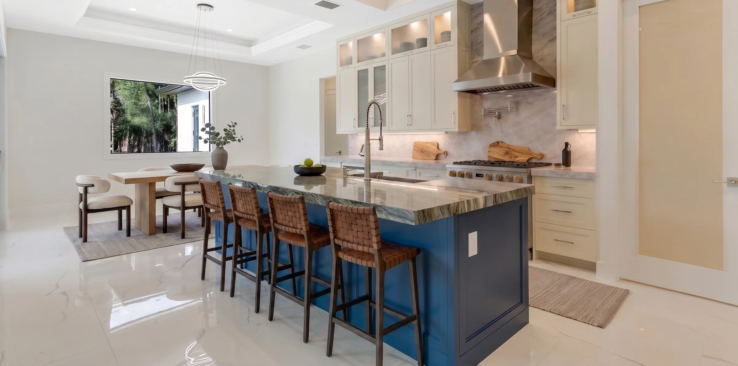 Gourmet kitchen with quartz countertops and custom cabinetry in Rookery Bay transitional coastal luxury home at Naples, FL by XL Homes custom home builder
