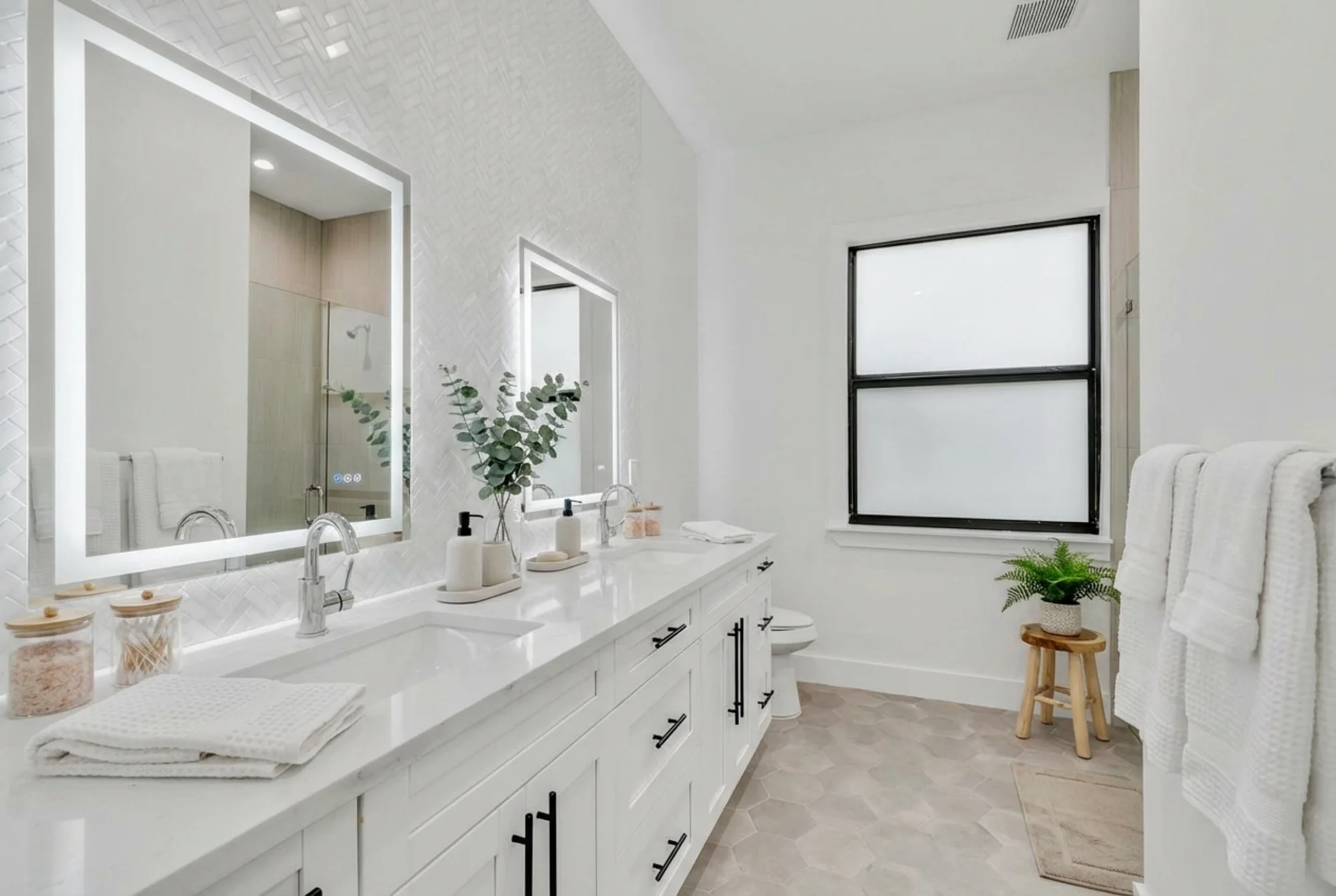 Luxury spa bathroom with marble tiles and designer fixtures in The Modern Haven modern minimalist home at 2747 6th Ave NE, Naples FL by XL Homes custom home builder