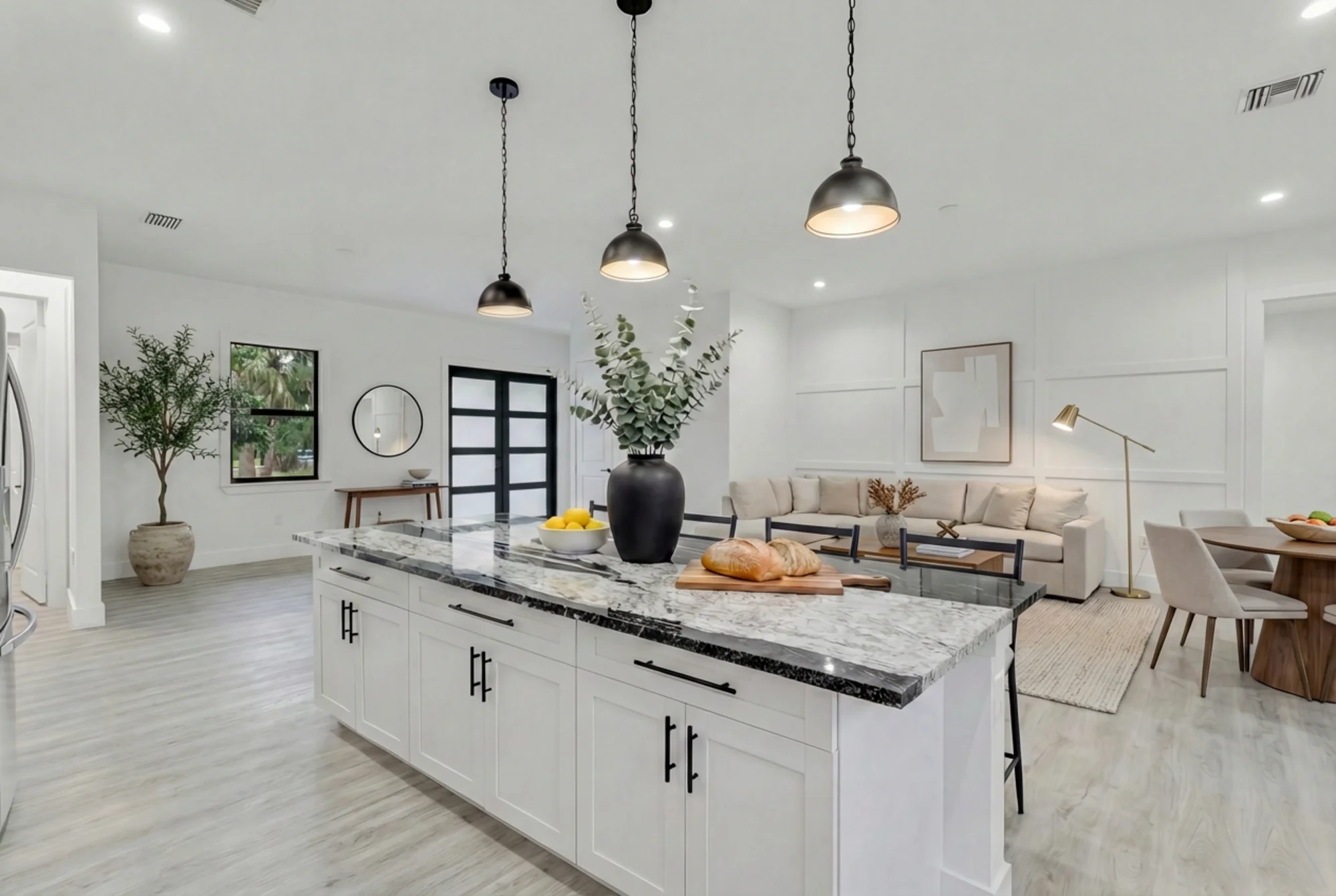 Gourmet kitchen with quartz countertops and custom cabinetry in The Modern Haven modern minimalist home at 2747 6th Ave NE, Naples FL by XL Homes custom home builder