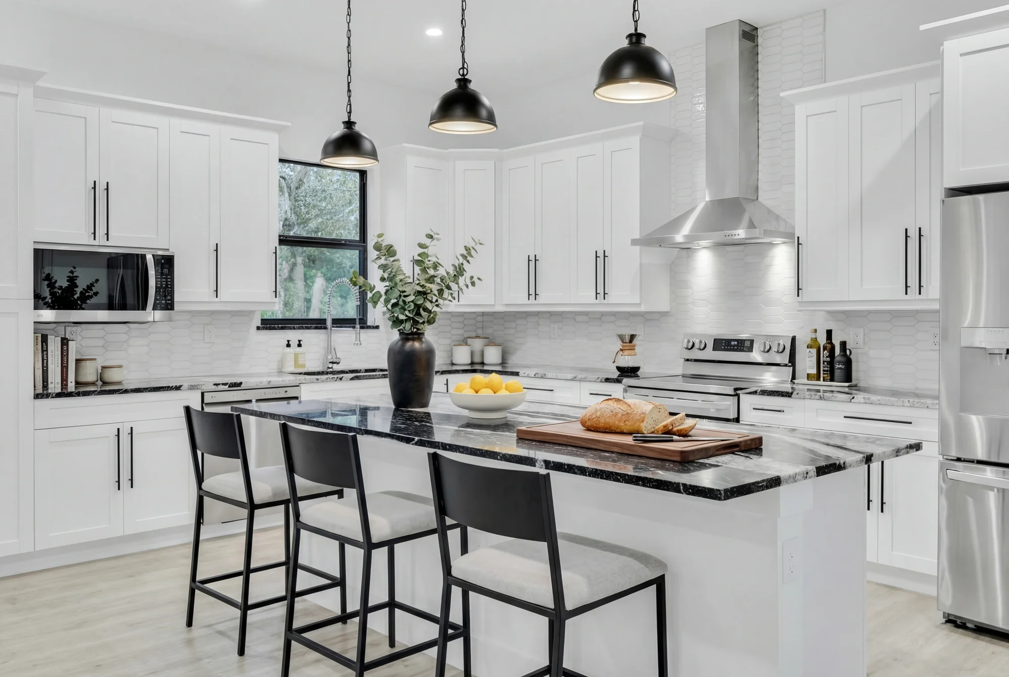 Gourmet kitchen with quartz countertops and custom cabinetry in The Modern Haven modern minimalist home at 2747 6th Ave NE, Naples FL by XL Homes custom home builder