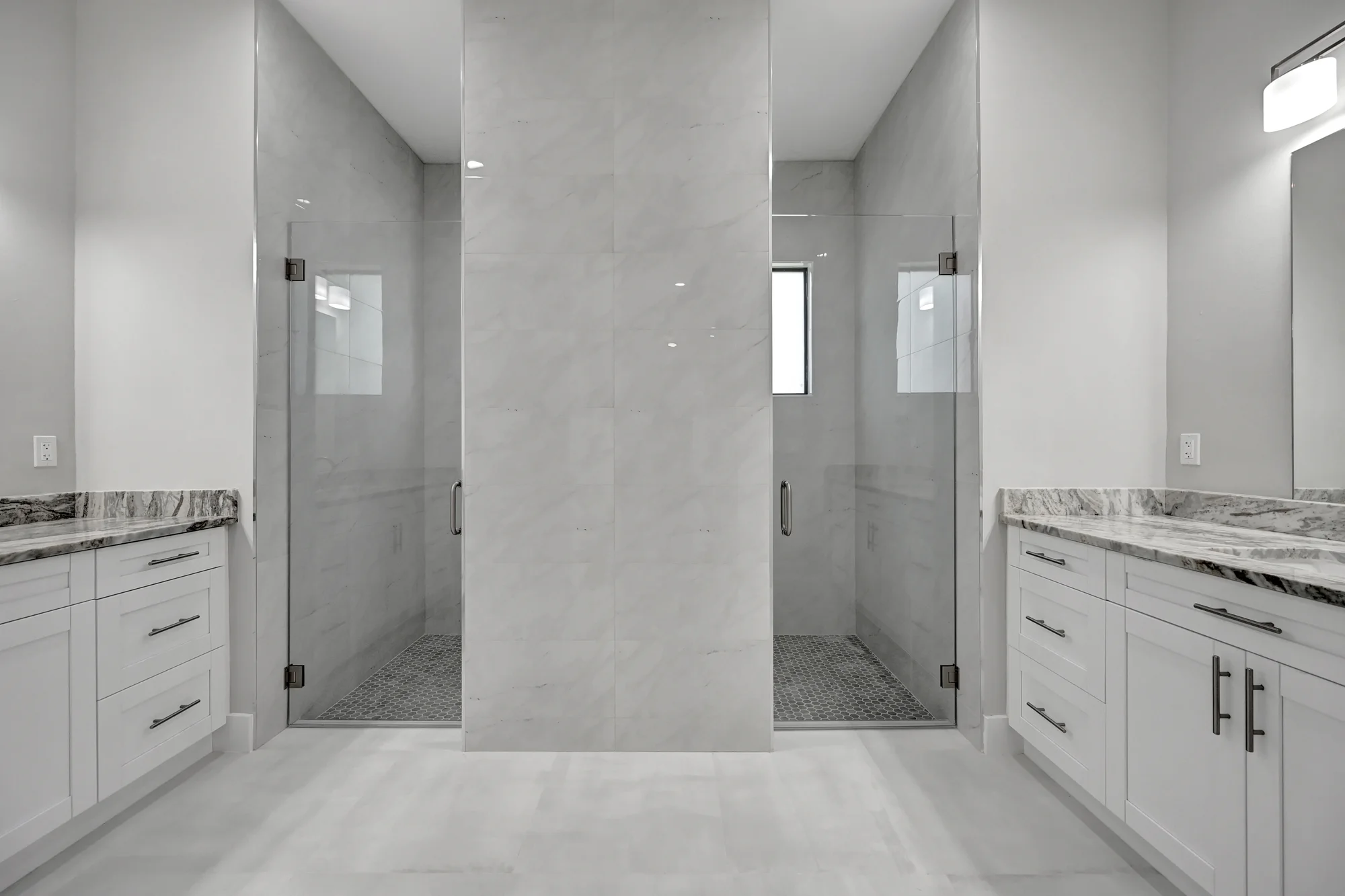 Luxury spa bathroom with marble tiles and designer fixtures in The Panorama Florida contemporary home at 70 33rd Ave NW, Naples FL by XL Homes custom home builder