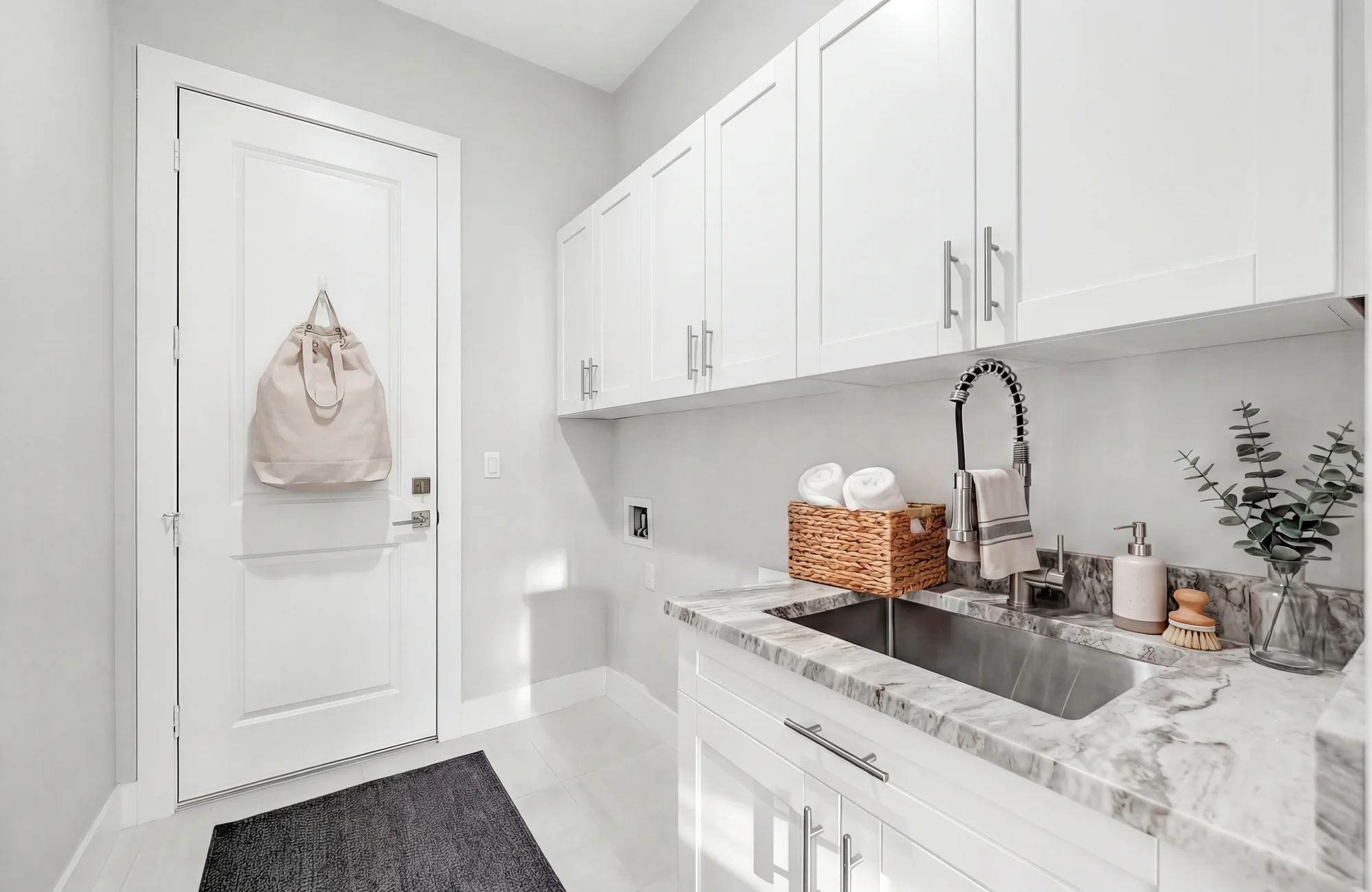 Premium laundry room with quartz countertops and cabinetry in The Panorama Florida contemporary home at 70 33rd Ave NW, Naples FL by XL Homes custom home builder