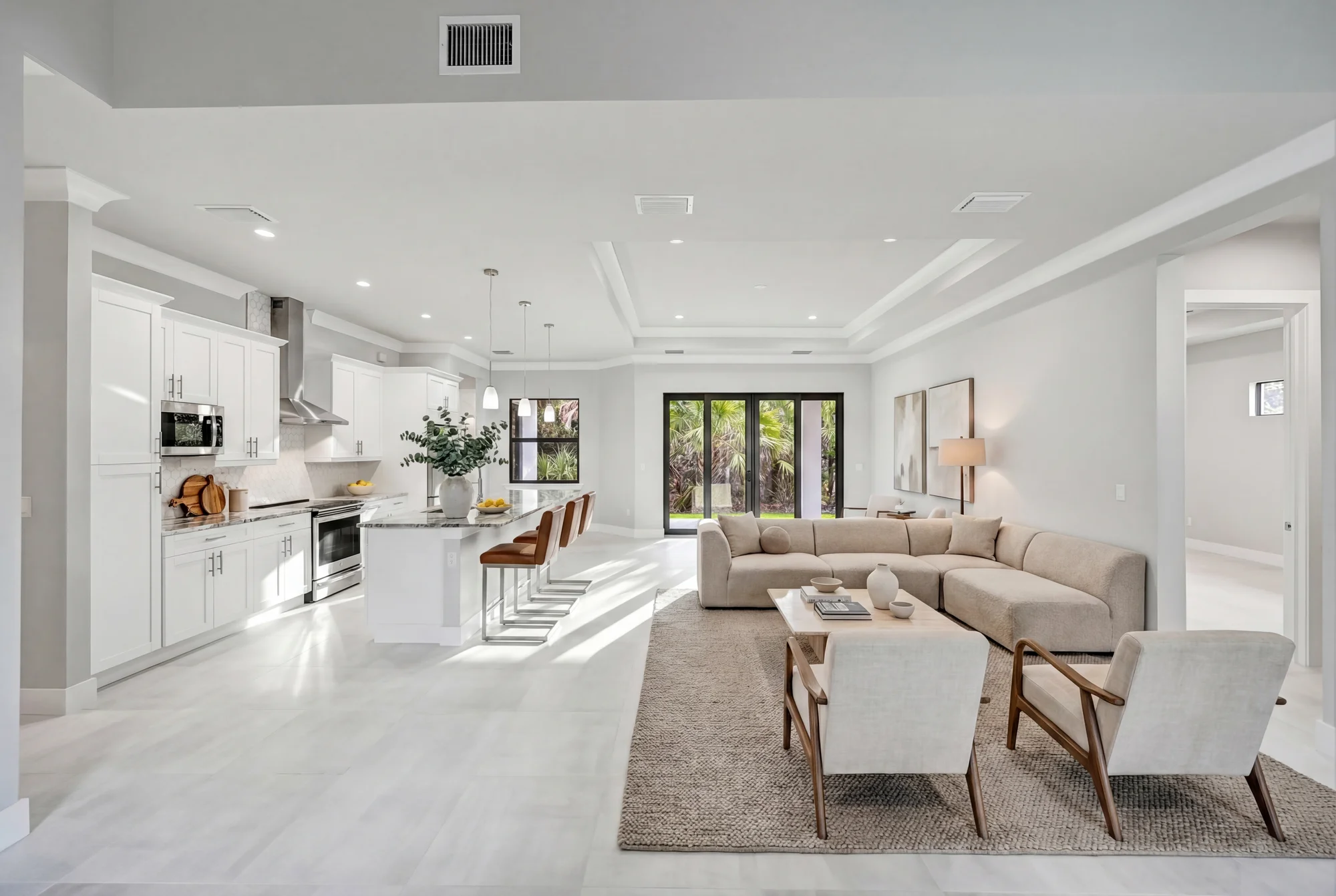 Open concept living room with high ceilings and natural light in The Panorama Florida contemporary home at 70 33rd Ave NW, Naples FL by XL Homes custom home builder