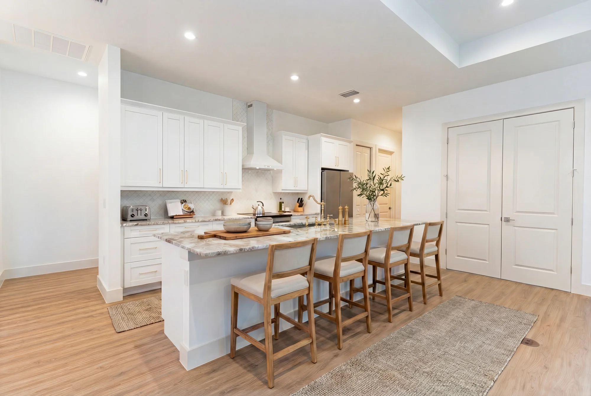 Gourmet kitchen with quartz countertops and custom cabinetry in The Sapphire contemporary waterfront home at 619 22nd St SE, Naples FL by XL Homes custom home builder