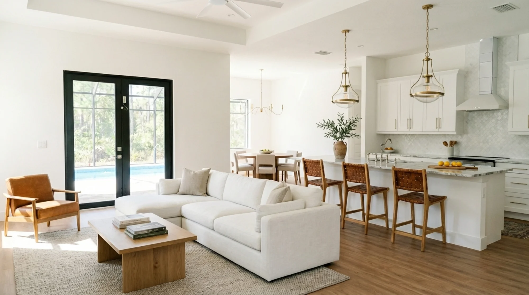 Open concept living room with high ceilings and natural light in The Sapphire contemporary waterfront home at 619 22nd St SE, Naples FL by XL Homes custom home builder