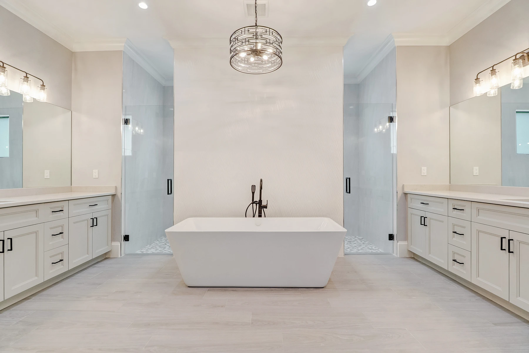 Luxury spa bathroom with marble tiles and designer fixtures in Remodeling Projects high-end remodeling home at Naples, FL by XL Homes custom home builder